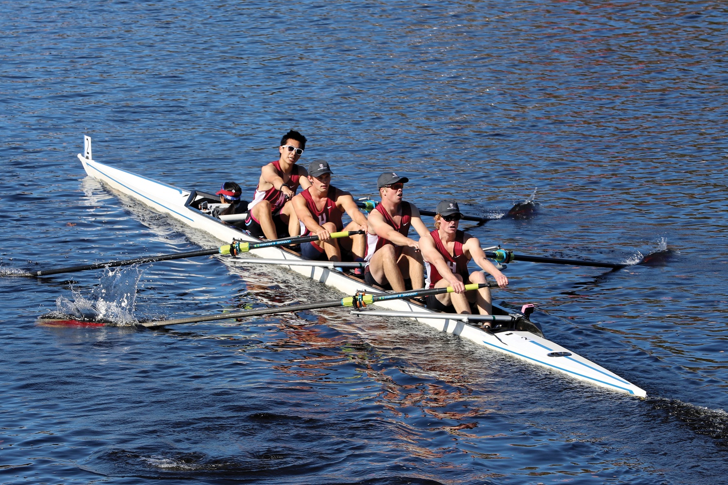 Matthew Shum, Emmett de Kanter, Westby Caspersen, and Lars Caspersen, led by coxswain Taybah Crorie, compete in the men’s club fours, one of three Harvard boats in the event.