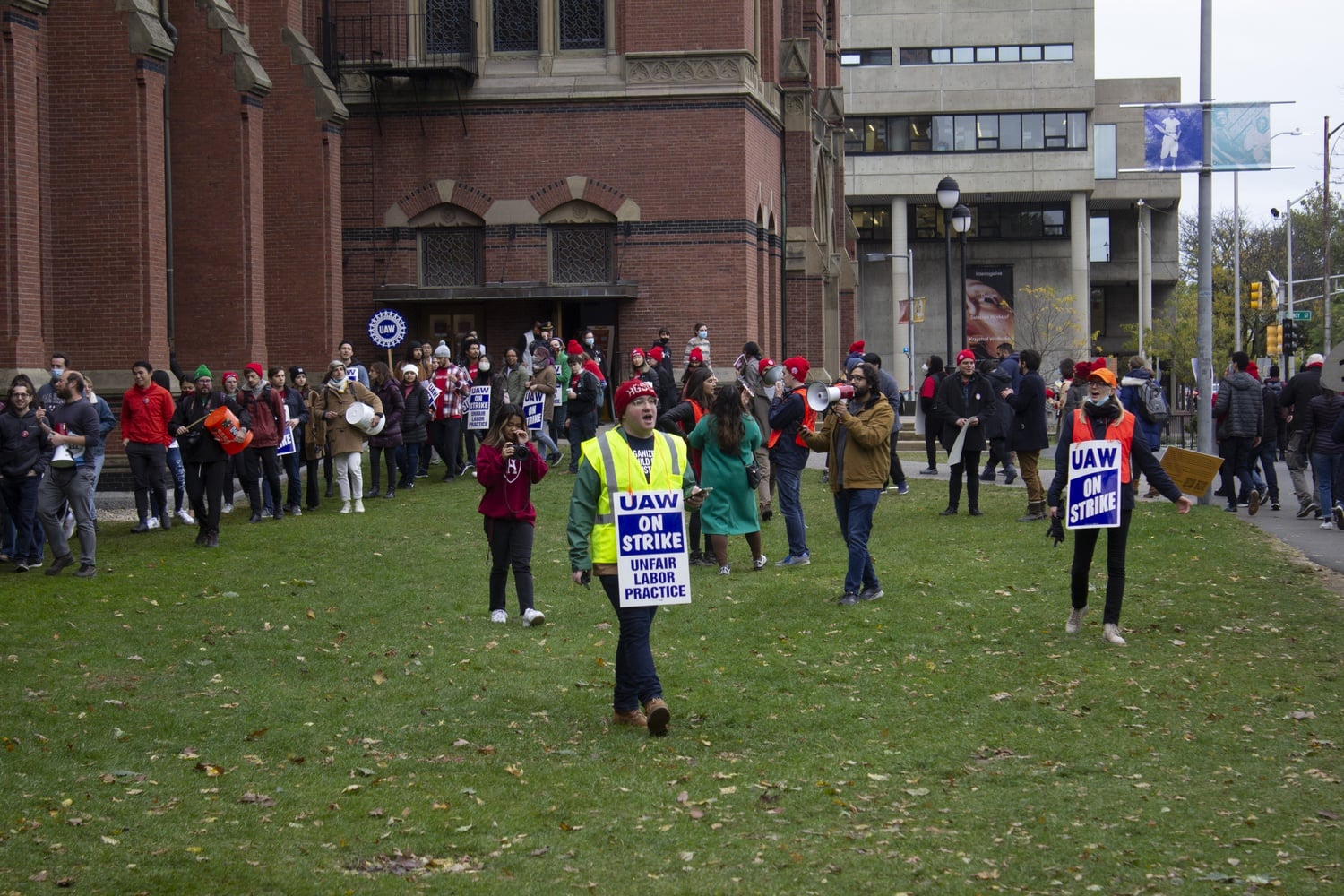 Strikers outside Sanders Theatre Friday afternoon. A group of demonstrators later interrupted a speech by University President Lawrence S. Bacow inside.