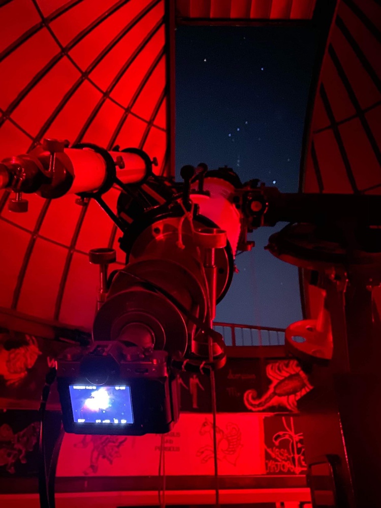 The Loomis-Michael Observatory is lit up red as the telescope captures the Orion Nebula. The observatory, located on the 10th floor of the Science Center, is run by Student Astronomers at Harvard-Radcliffe.