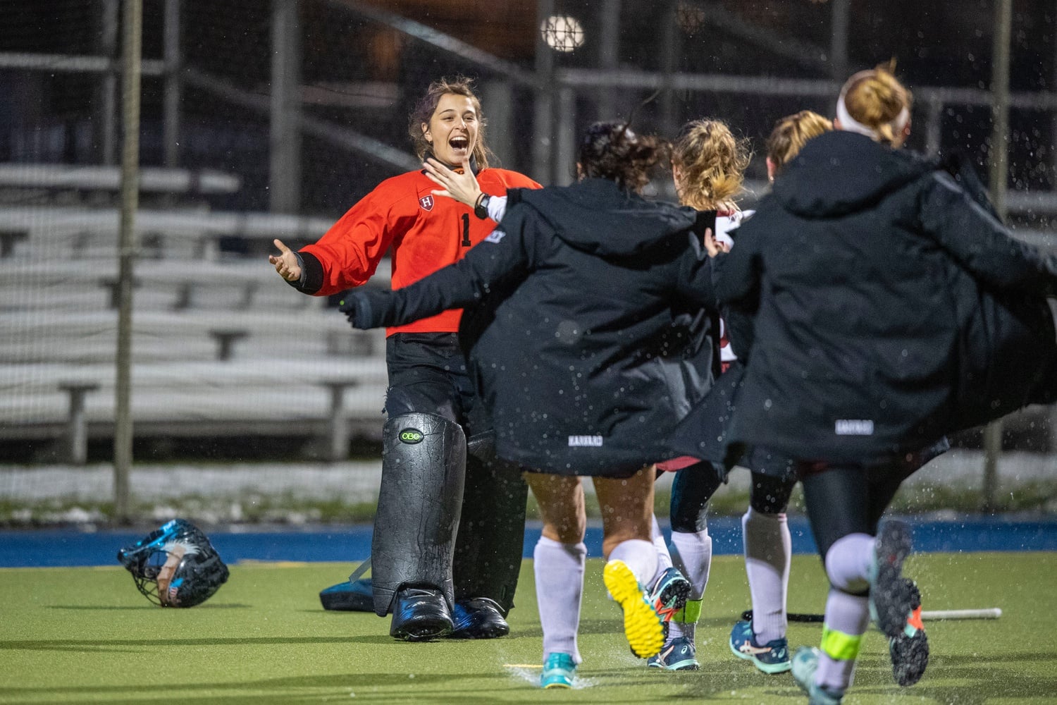 The Crimson rushes goalkeeper Ellie Shahbo after the junior goalie stifled Michigan's final penalty shootout attempt to send Harvard into the Final Four.