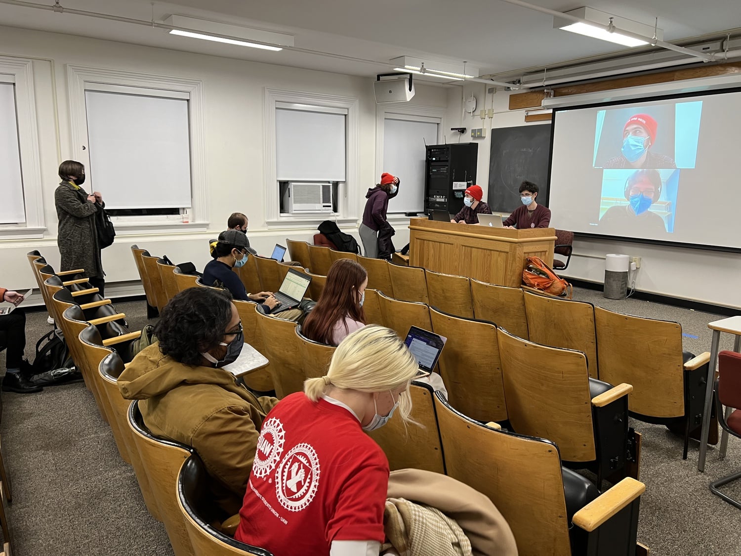 Members of Harvard Graduate Students Union-United Automobile Workers file into Emerson 305 ahead of the special membership meeting Monday evening, at which they discussed the union's impending strike deadline.