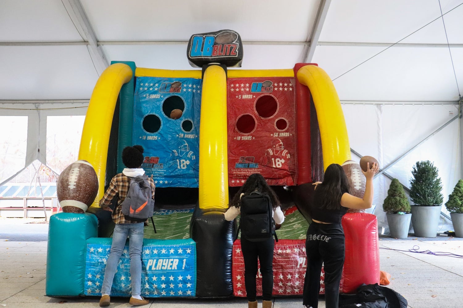 At an event during Harvard-Yale Spirit Week, hosted by the Harvard College Events Board, students played QBBlitz, in which they threw footballs at a goal.