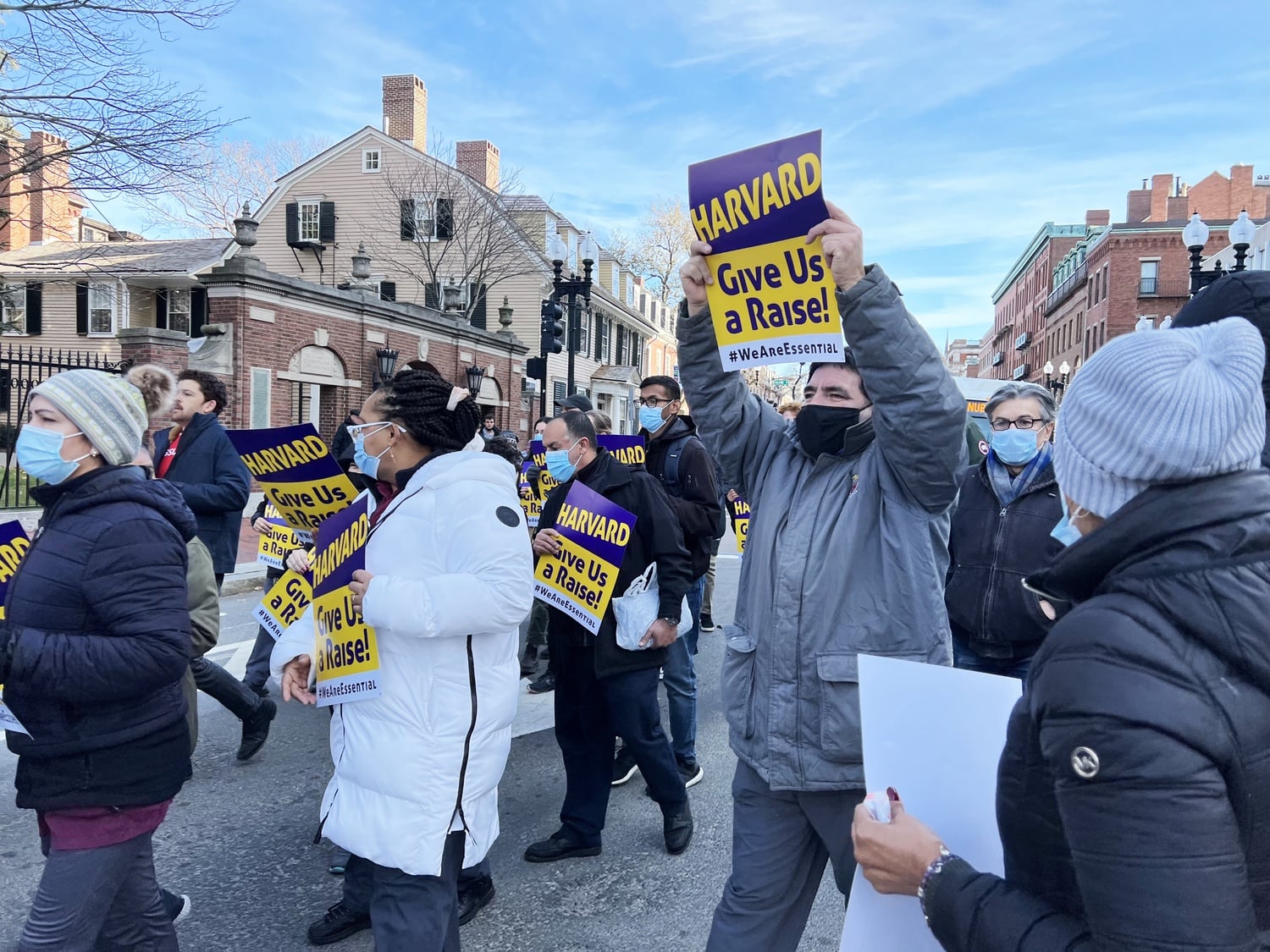 More than 80 custodians, security officers, and their supporters marched on Massachusetts Avenue Tuesday in support of raises in their next contract with the University.