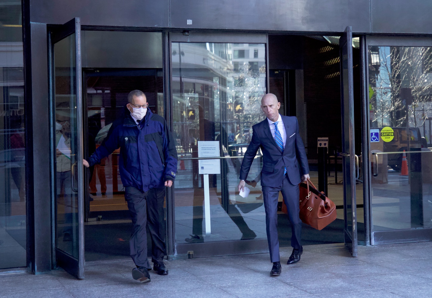 Harvard professor Charles M. Lieber (left) exits the John J. Moakley U.S. Courthouse on Friday with his lawyer, Marc L. Mukasey. Lieber is facing trial for allegedly lying to federal authorities about his ties to a Chinese recruitment program.