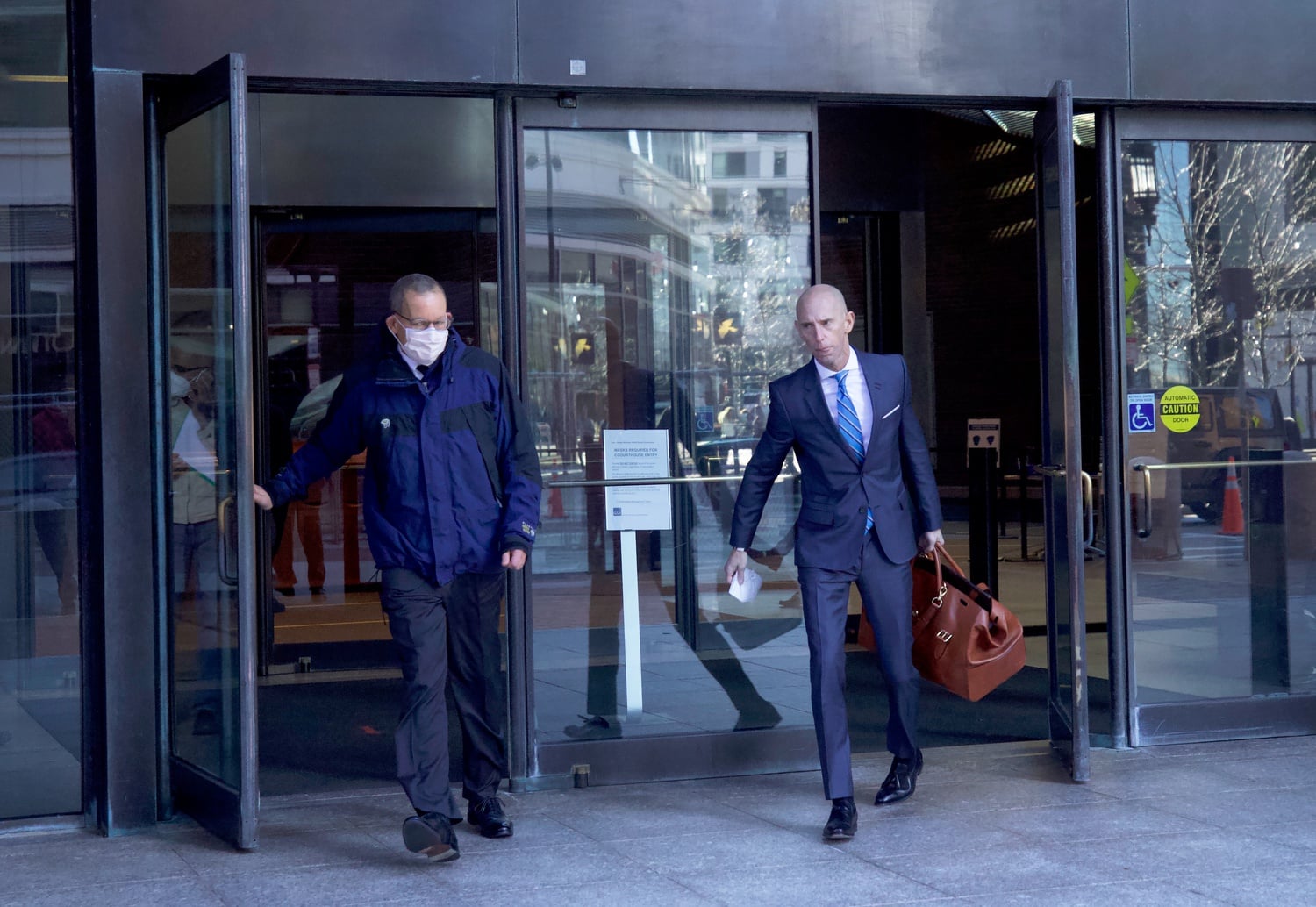 Harvard professor Charles M. Lieber (left) exits the John J. Moakley U.S. Courthouse on Friday with his lawyer, Marc L. Mukasey. Lieber is facing trial for allegedly lying to federal authorities about his ties to a Chinese recruitment program.