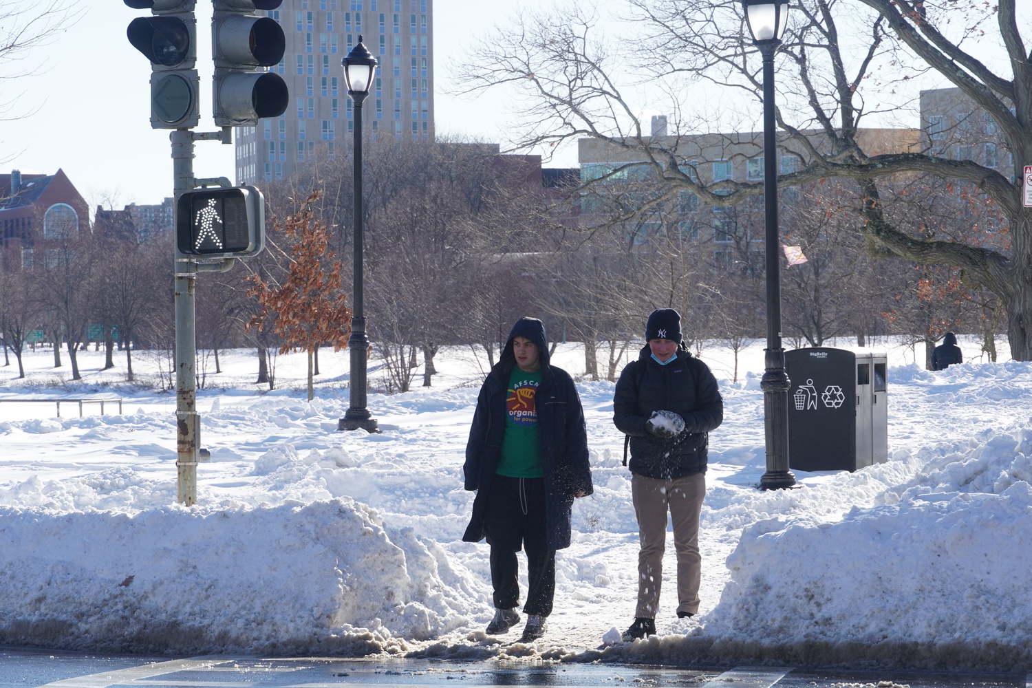 Two pedestrians prepare to cross Memorial Drive on Sunday.