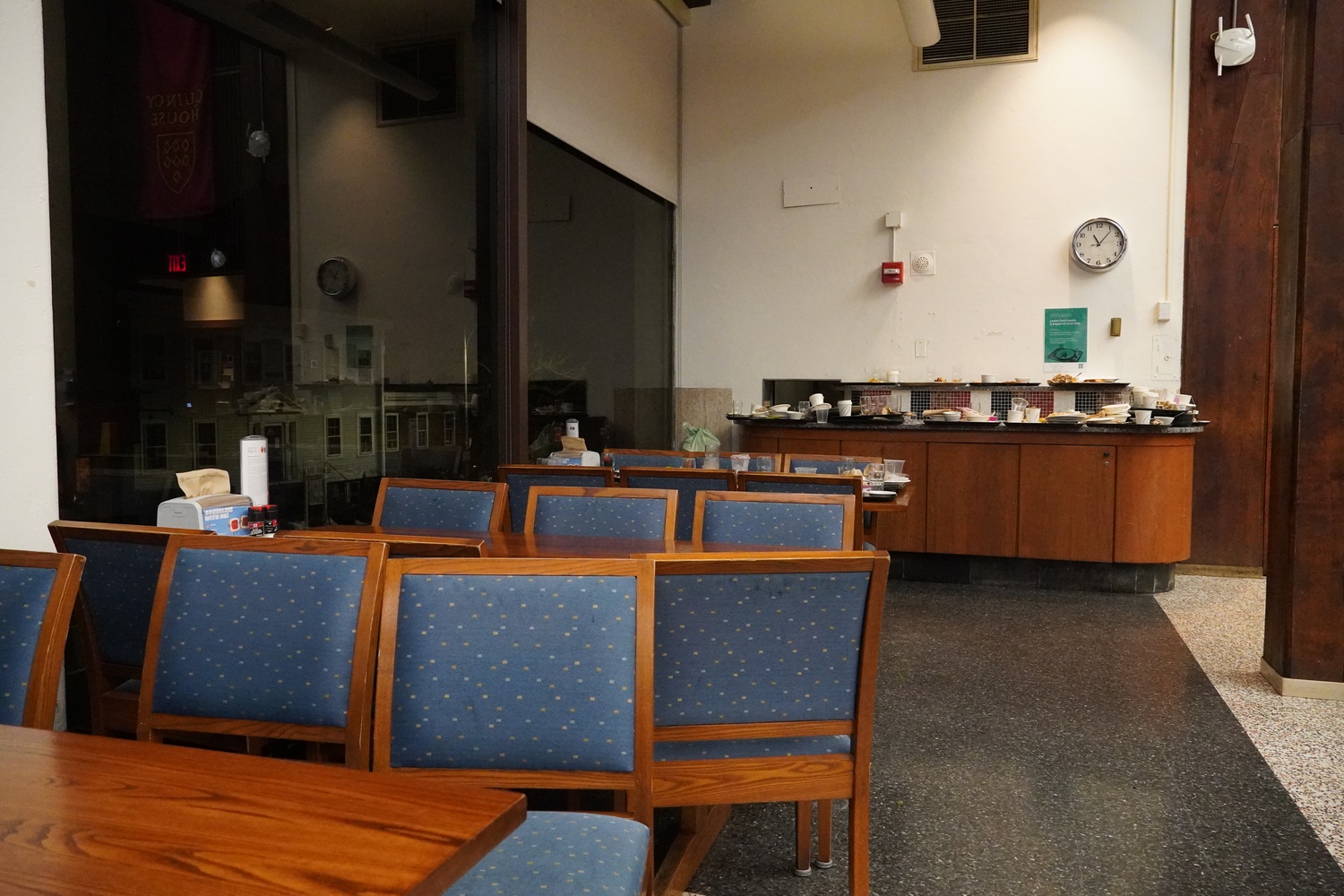Plates and food waste crowd the tray return at Quincy dining hall.