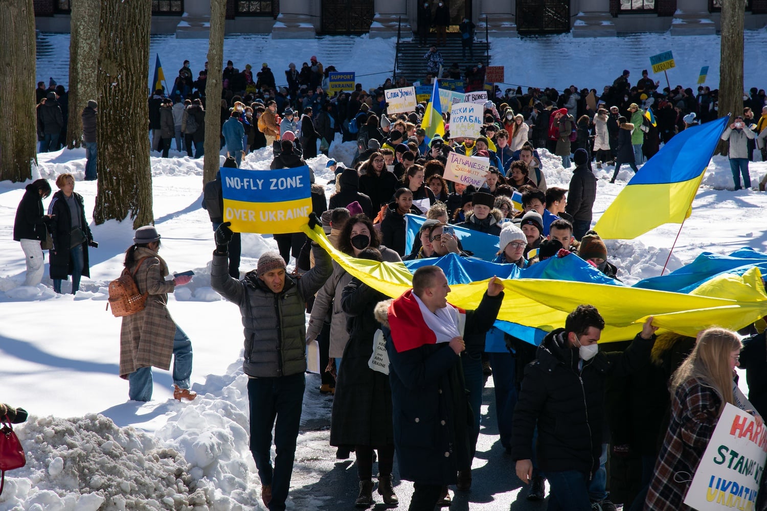 Hundreds of demonstrators march through Harvard Yard in a February 2022 rally denouncing Russia's invasion of Ukraine.