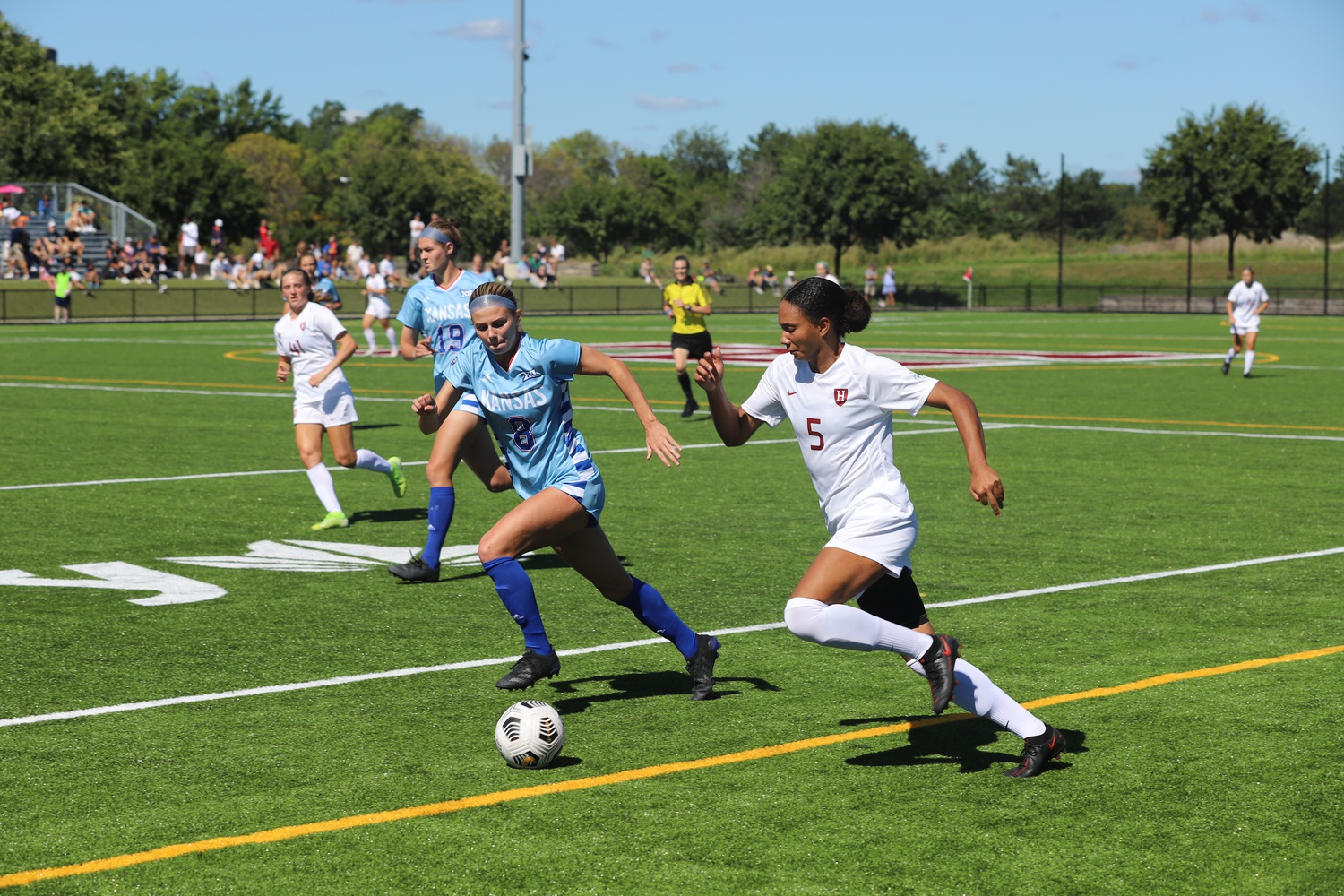 First-year defender Jade Rose pushes the ball down the pitch during a game against Kansas on Sept. 19. Harvard went on to win 2-1.