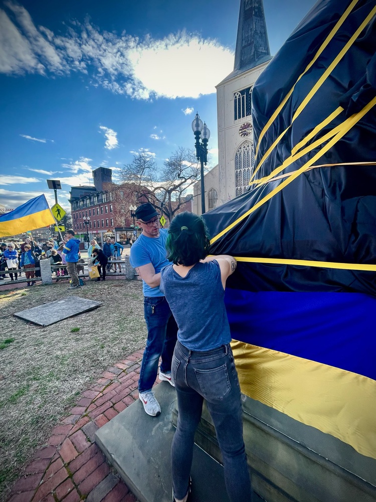The Charles Sumner Statue on Massachusetts Avenue in Cambridge was wrapped in the colors of the Ukrainian flag.