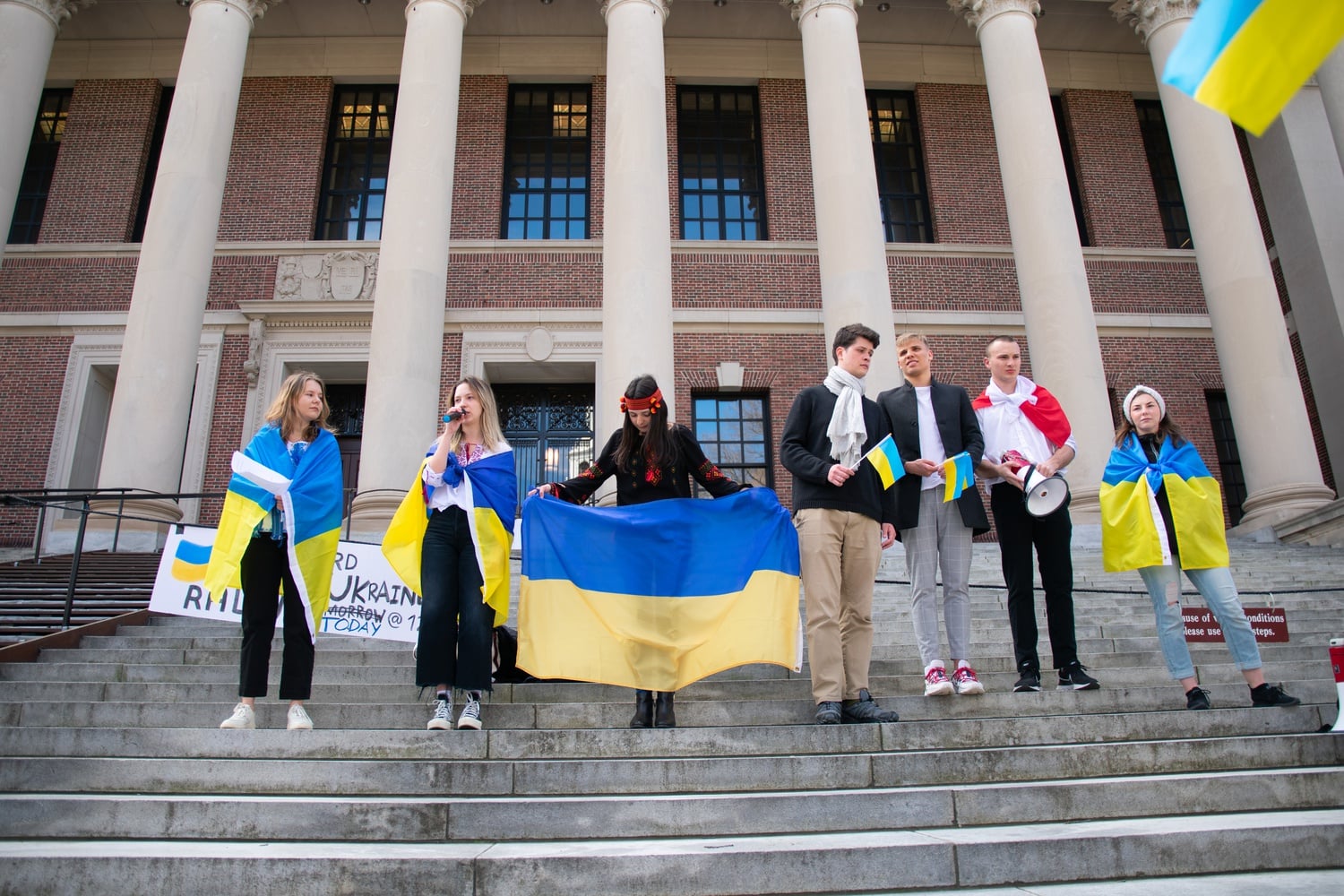 Supporters of Ukraine stand on the steps of Widener Library.