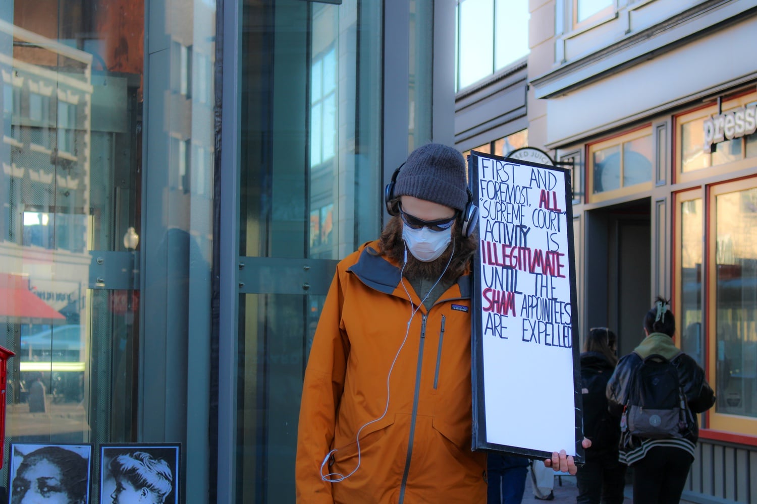 A protestor holds a sign criticizing the Supreme Court at the abortion rights rally in Harvard Square.
