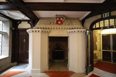Cover image for Adams House to Remove Fireplace Bearing Boarded-Up Racist Sculptures During 2023 Renovations
