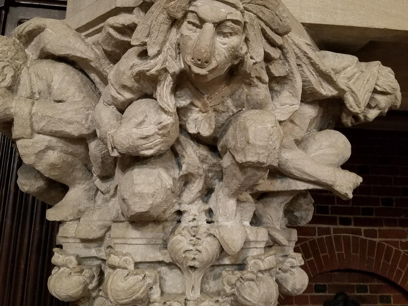A close-up shot of the purported Indigenous figure with a large headdress, ball in hand, and a ring hanging from its nose.