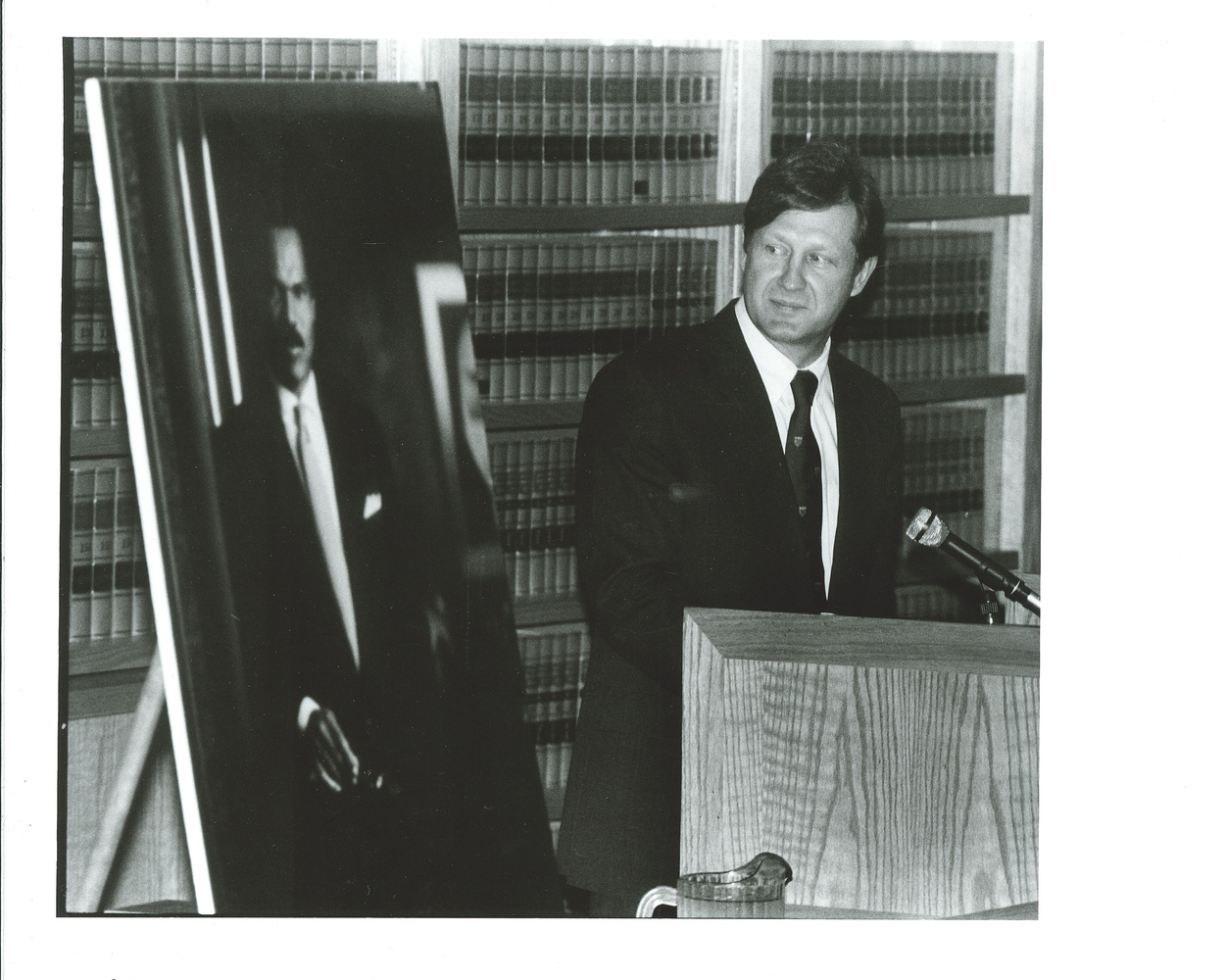 Law School Dean Robert Clark looking at a portrait of Reginald Lewis during the ceremony dedicating the International Law Center, April 23 1993. UAV 605.295.21 Box 1 (1993-04-30).