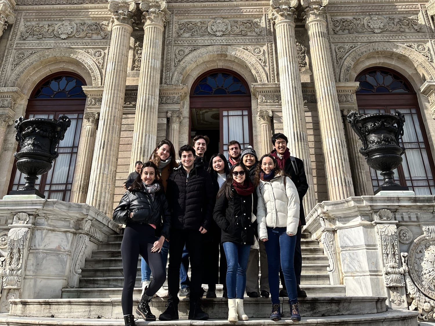 Trip participants pose in front of Istanbul's Dolmabahce Palace.