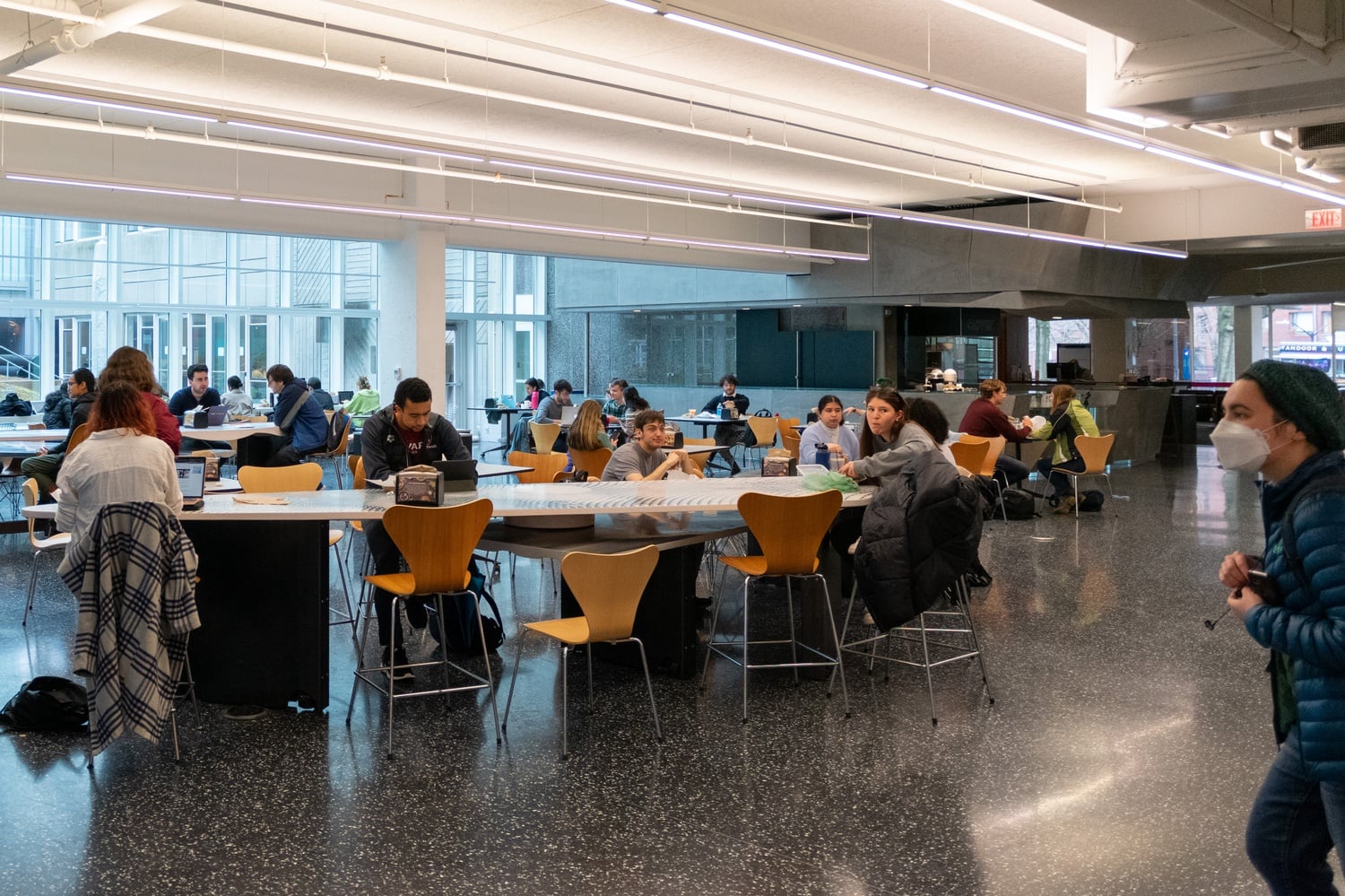 With indoor masking now optional, most students study or converse unmasked at Clover in the Science Center. Some immunocompromised students criticize Harvard for not continuing Covid accommodations, like remote learning options.