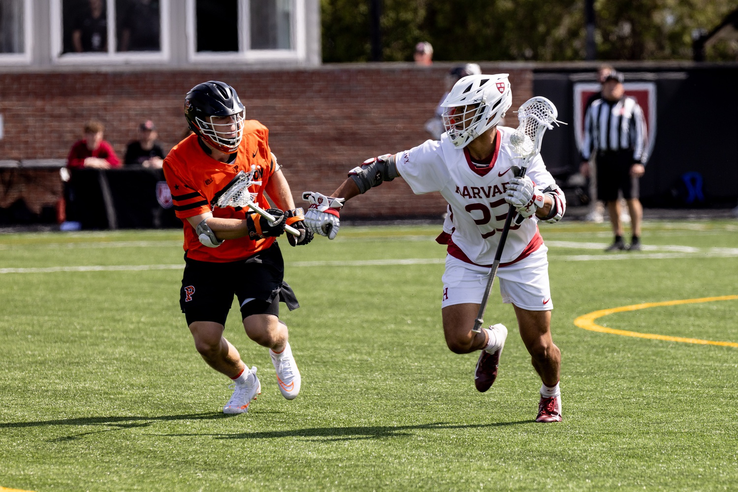 Junior midfielder Isaiah Dawson sizes up his Princeton defender during a 19-16 victory over the Tigers on Saturday. Dawson helped Harvard to an epic comeback, ensuring that the Crimson will control its playoff destiny next week against Yale.