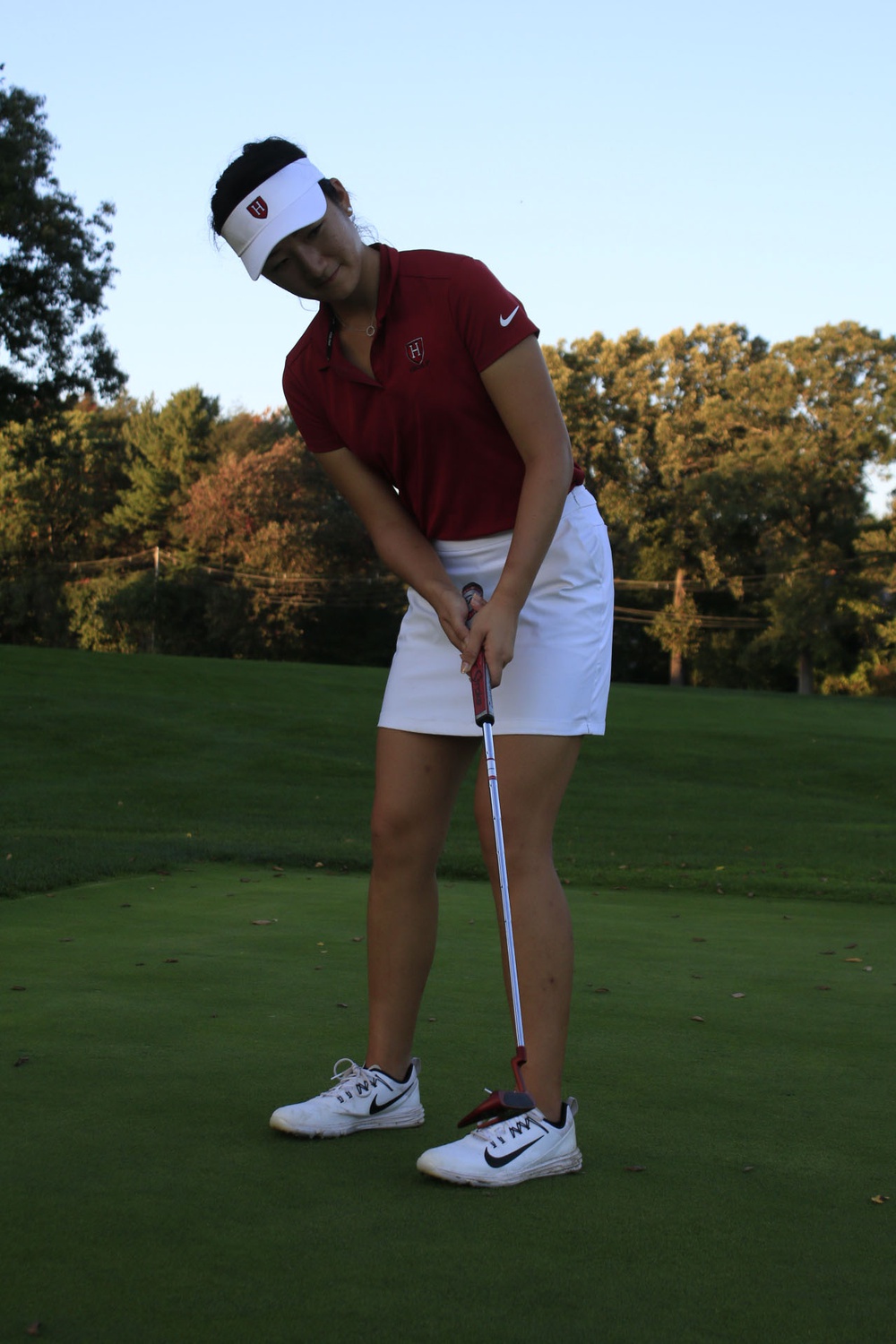Senior captain Anina Ku practices her putting in 2018. Last weekend, Ku helped lead the Crimson to a third-place finish in the Ivy League Championships