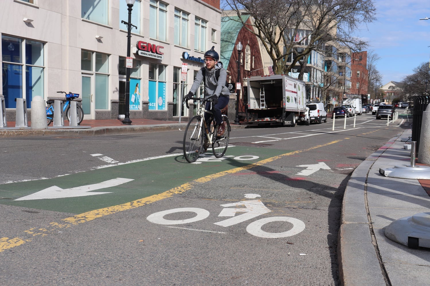 Cyclist uses the bike lane on Brattle Street. Cambridge's bike lane politics are contested and complicated; here is what they are and where they stand.