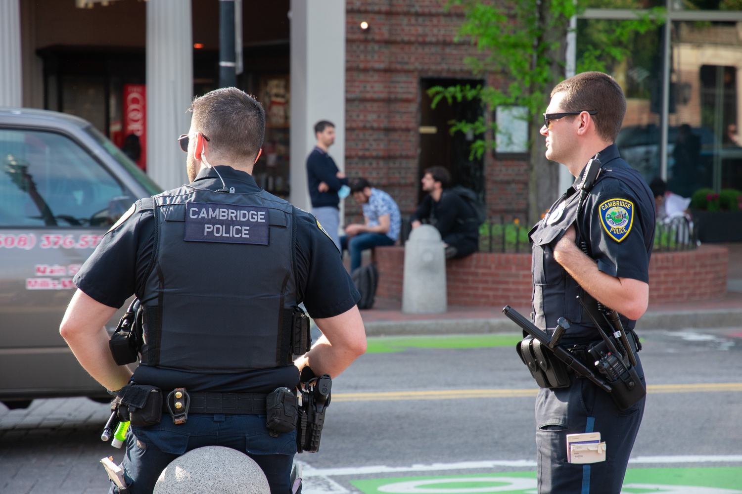 A pair of Cambridge Police Department officers stand in Harvard Square.