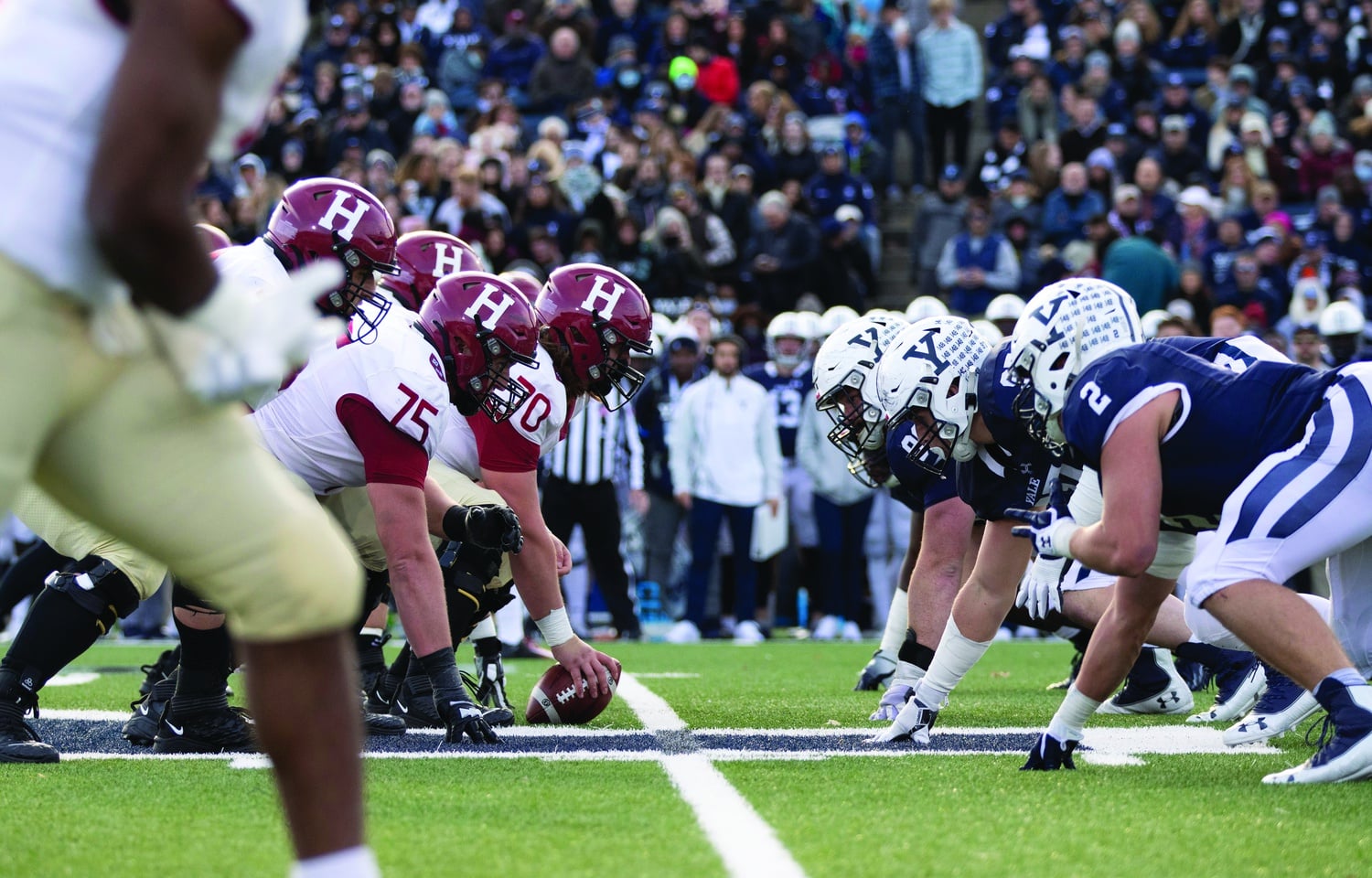 Harvard sophomore offensive lineman Scott Elliot prepares to snap the ball to junior quarterback Luke Emge in Harvard's 34-31 comeback victory over Yale on Nov. 20, 2021.