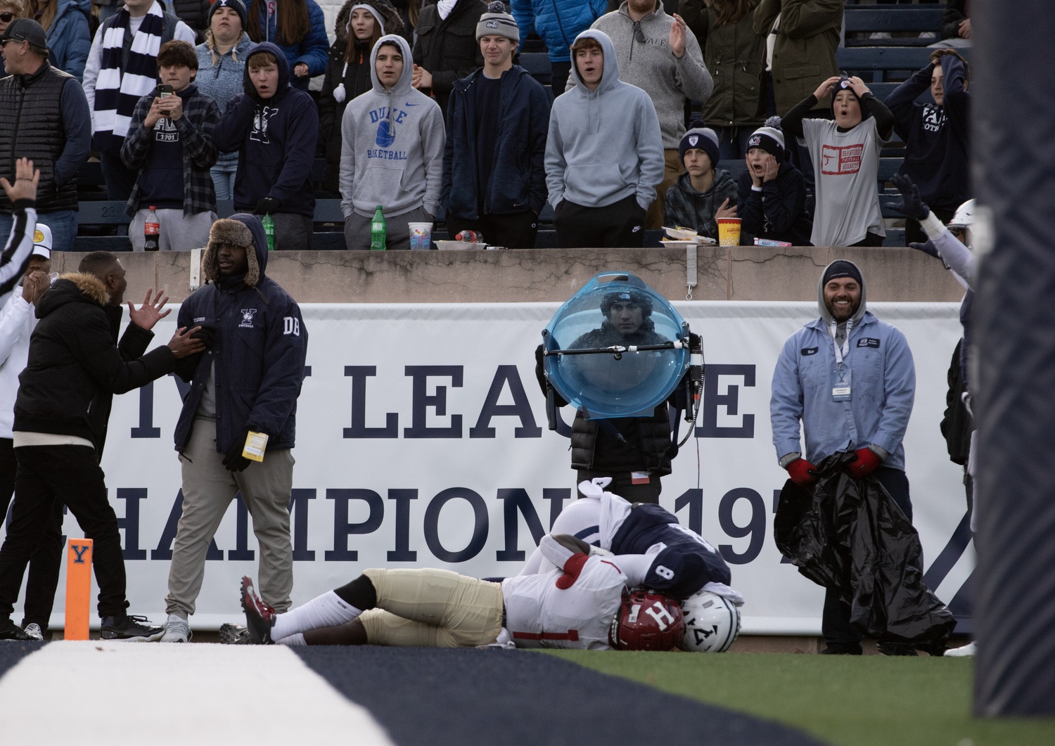 Junior wide receiver Kym Wimberly lies in the back of the end zone after making a 12-yard touchdown reception to secure the Crimson's 34-31 victory over Yale on Nov. 20, 2021.
