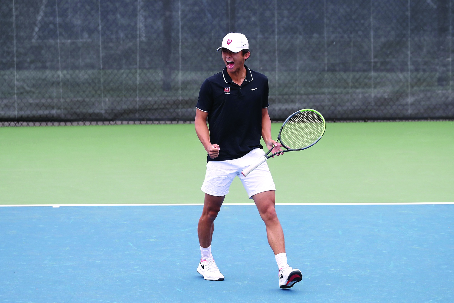 Harvard senior captain Brian Shi celebrates after clinching the Ivy League title in a victory over Yale on April 24. Shi helped lead the Crimson to one of its most successful seasons ever.