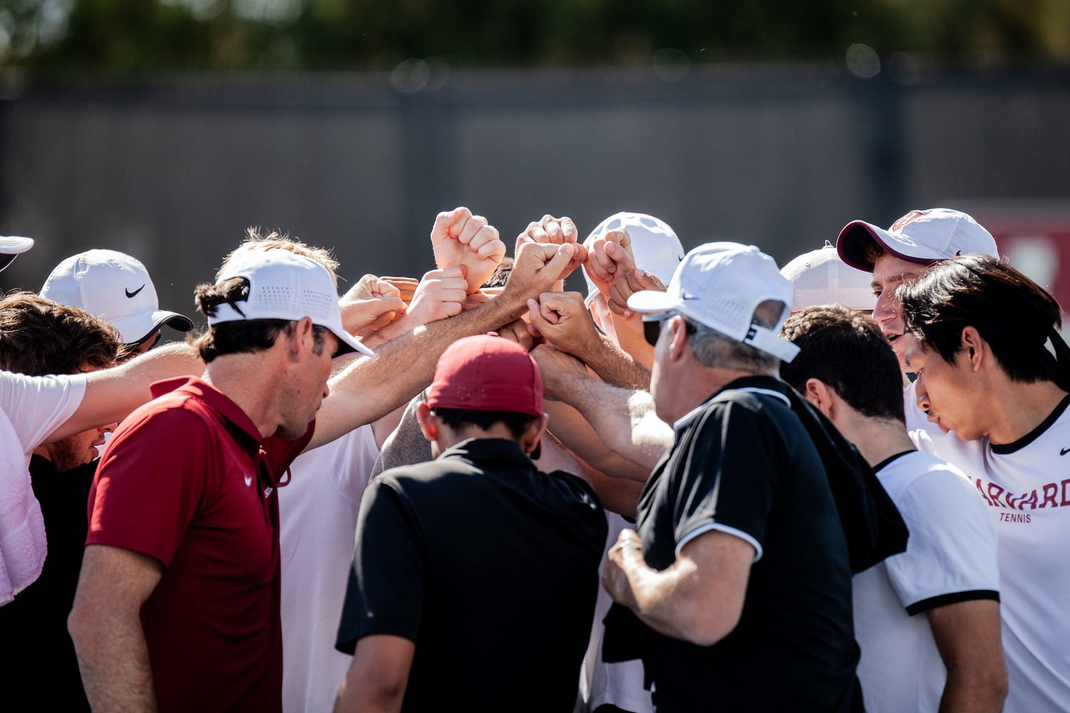 Harvard's men's tennis team huddles during a 5-2 win over Princeton on April 16. The camaraderie of the team helped it claim its 30th Ivy League championship.