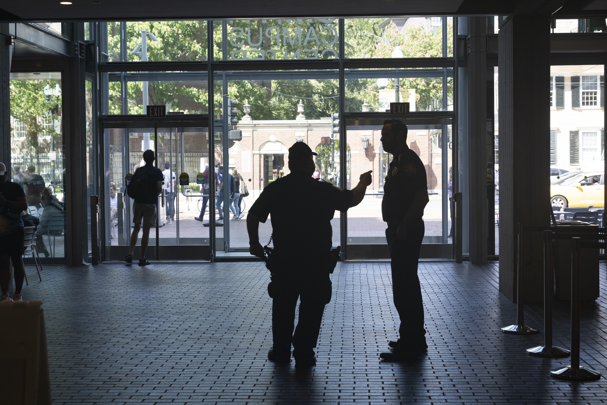Two Harvard University Police officers stand in the Smith Center.