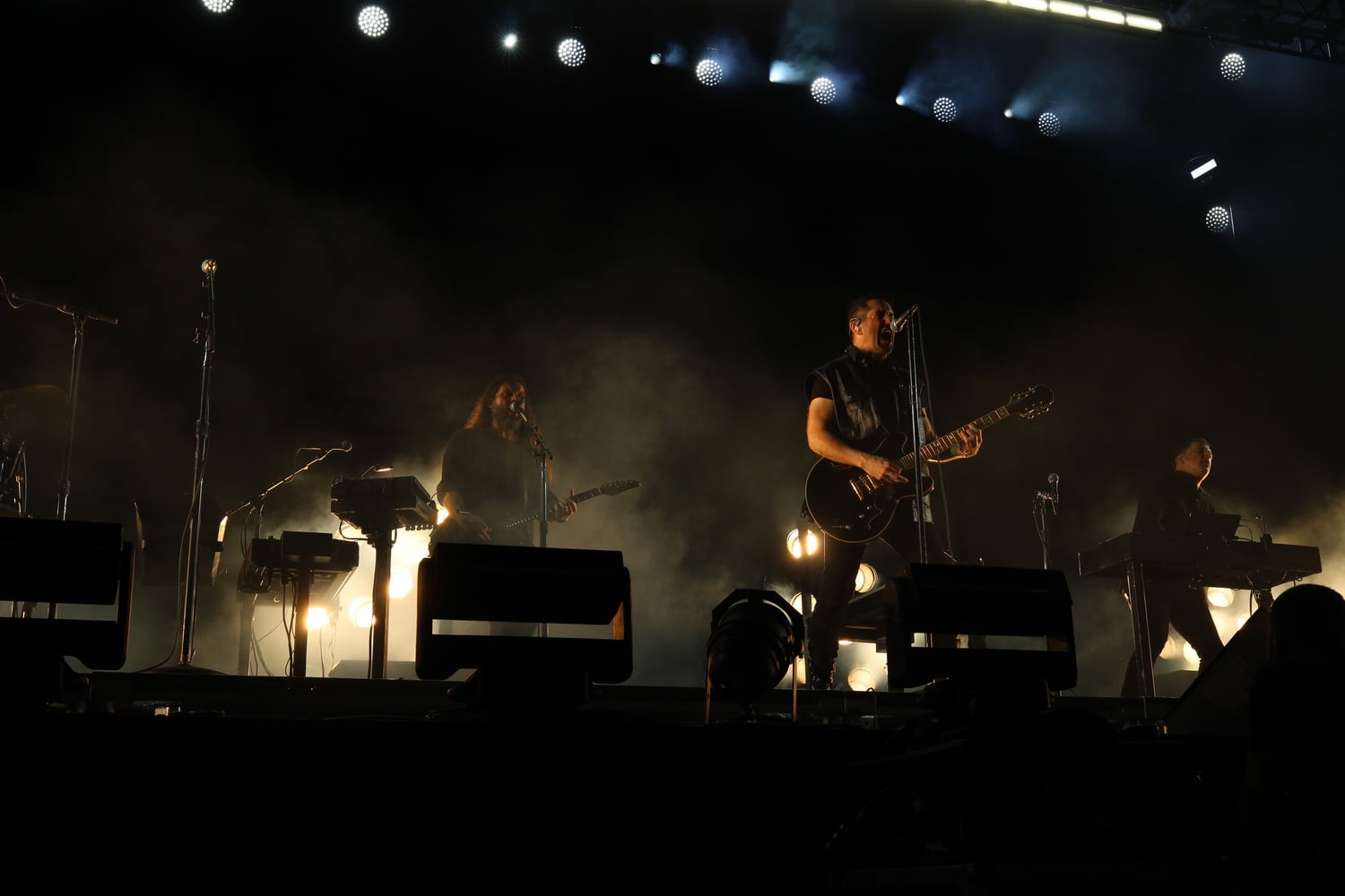 The touring band for Nine Inch Nails includes Robin Finck on guitar, Alessandro Cortini on the bass, and Ilan Rubin on the drums.