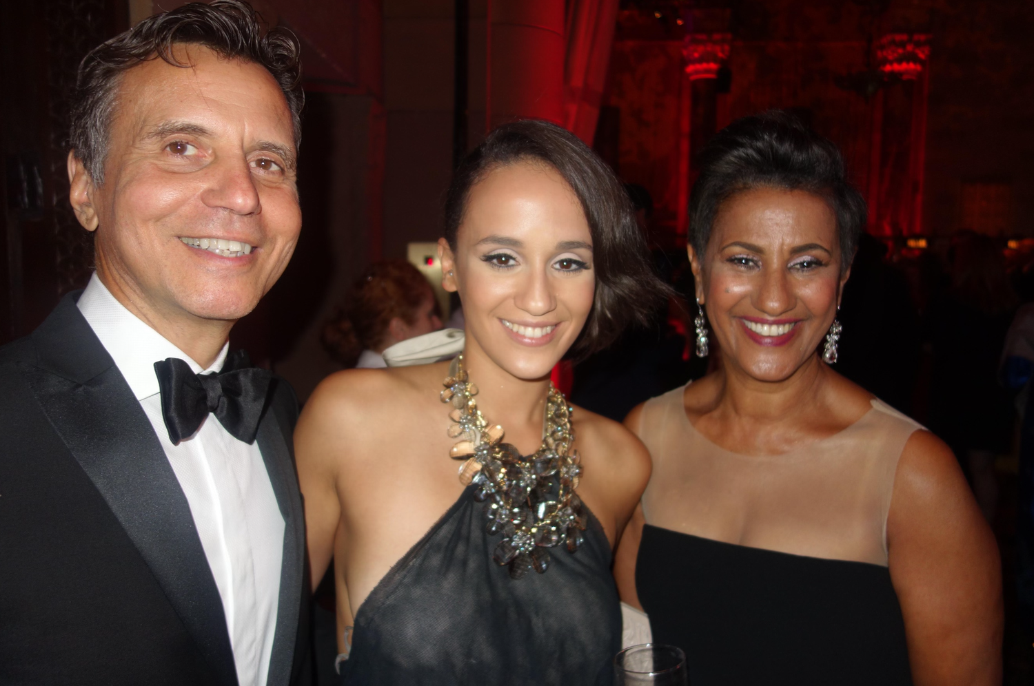 Clarence O’Neill “Neil” Brown III ’74, Rachel Amsale Brown ’10, and designer Amsale Aberra pose together.