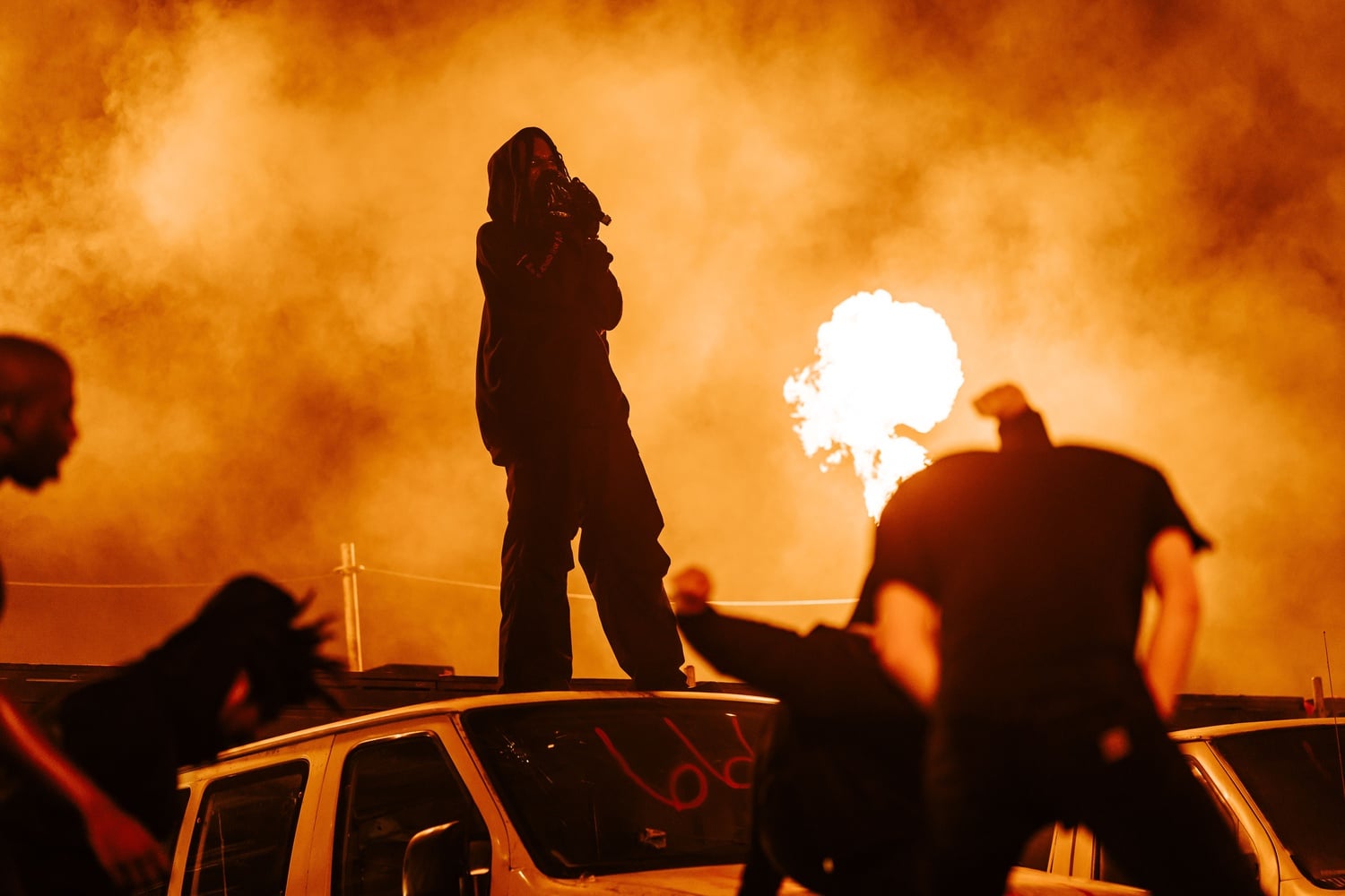 Playboi Carti raps atop a burning white van at Rolling Loud Miami 2022.