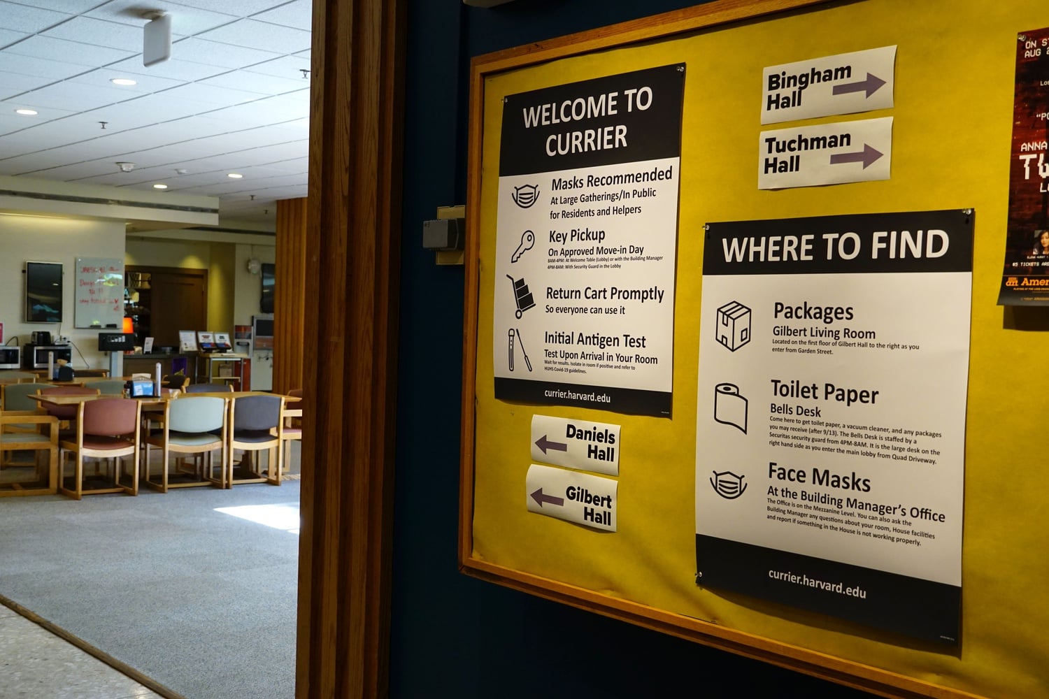 Guidelines for masking and antigen testing are posted on a bulletin board in Currier House.