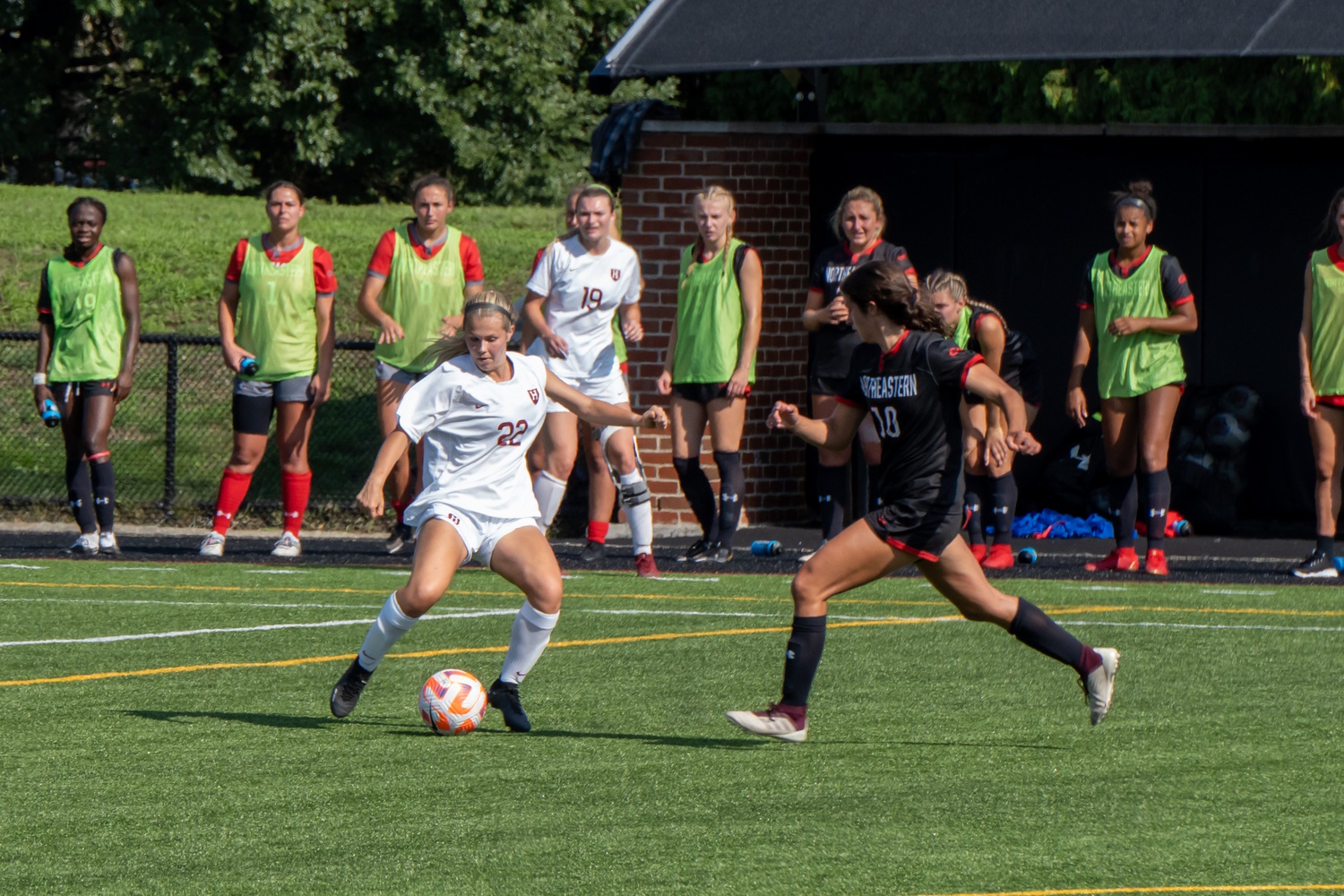 Senior midfielder Hollyn Torres battles to defend and maintain possession against Northeastern forward Rose Kaefer.