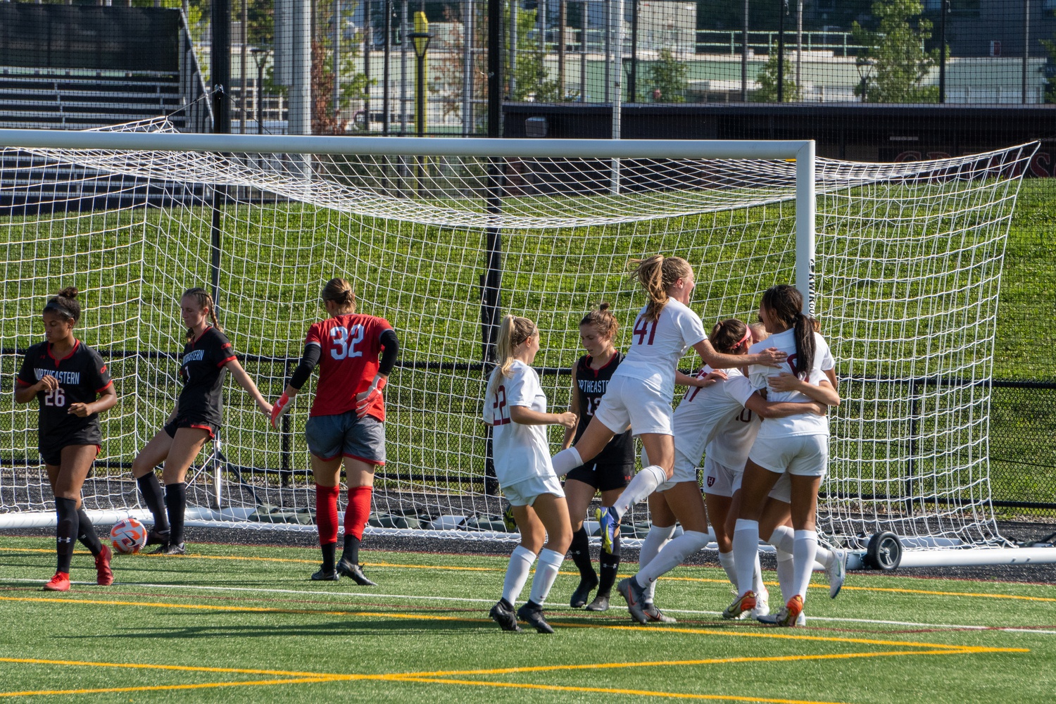 Harvard celebrates seconds after sophomore forward Ainsley Ahmadian scores a header off the corner kick from sophomore midfielder Aslaug Gunnlaugsdottir to put Harvard up 3-2 in the second half over Northeastern. Harvard would hold on to win its home opener 3-2.