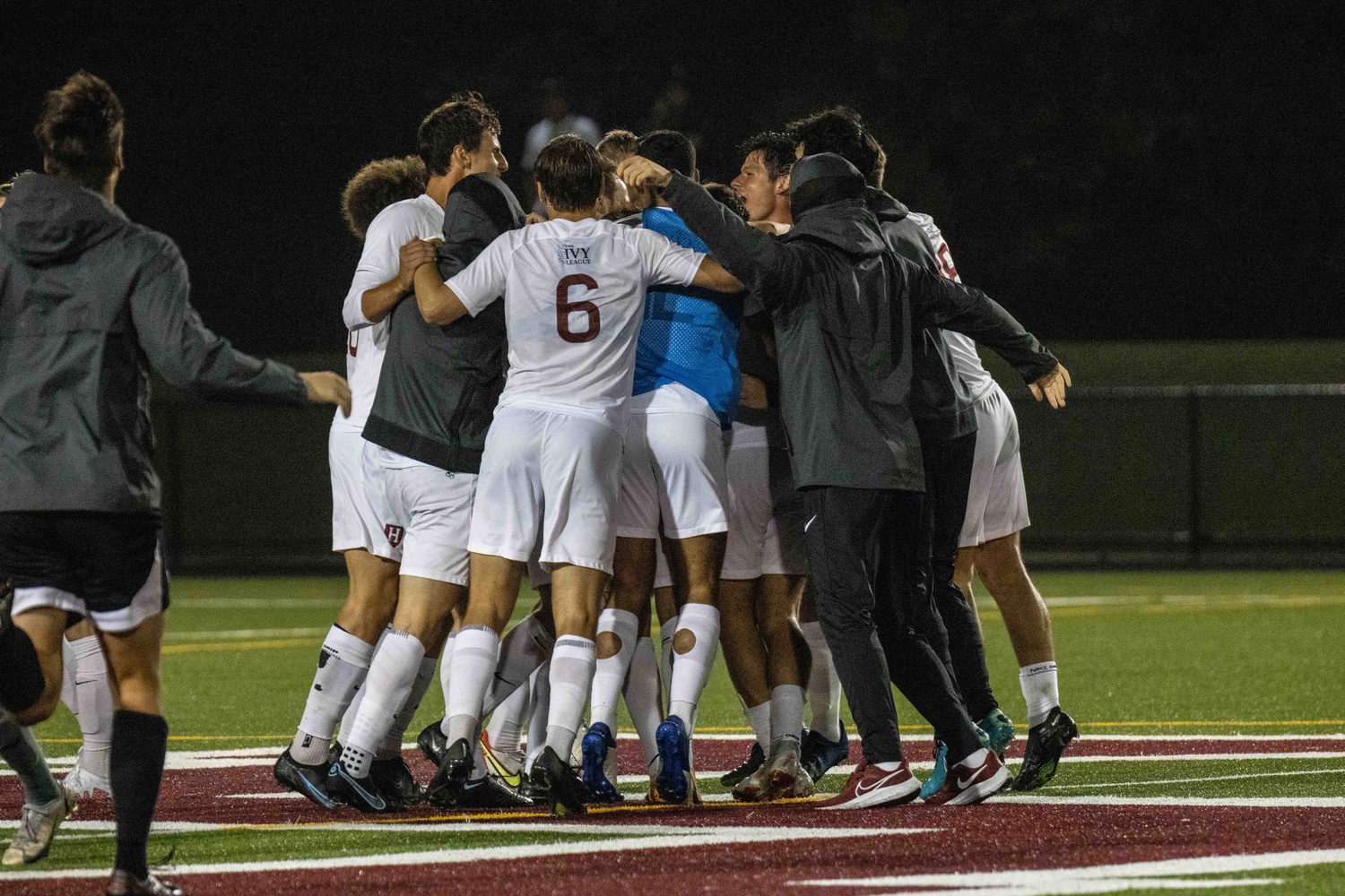 Harvard men's soccer celebrates after a tight victory against Bryant University.