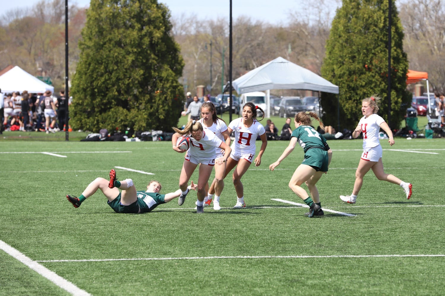A Harvard women's rugby player evades a Dartmouth tackler in a 24-17 victory in the championship game of the Ivy 7s tournament on April 23 at Mignone Field.