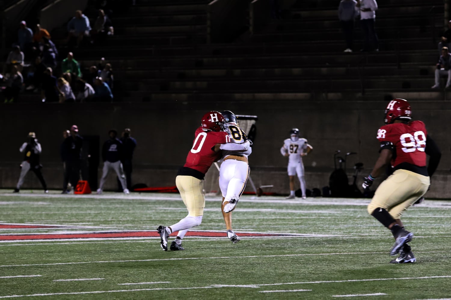 Senior cornerback Alex Washington tackles Merrimack wide receiver Hayden Fisher in Harvard's 28-21 overtime victory on Friday. Washington came up clutch when it mattered, batting down Gavin McCusker's desperation pass at the end of the game.