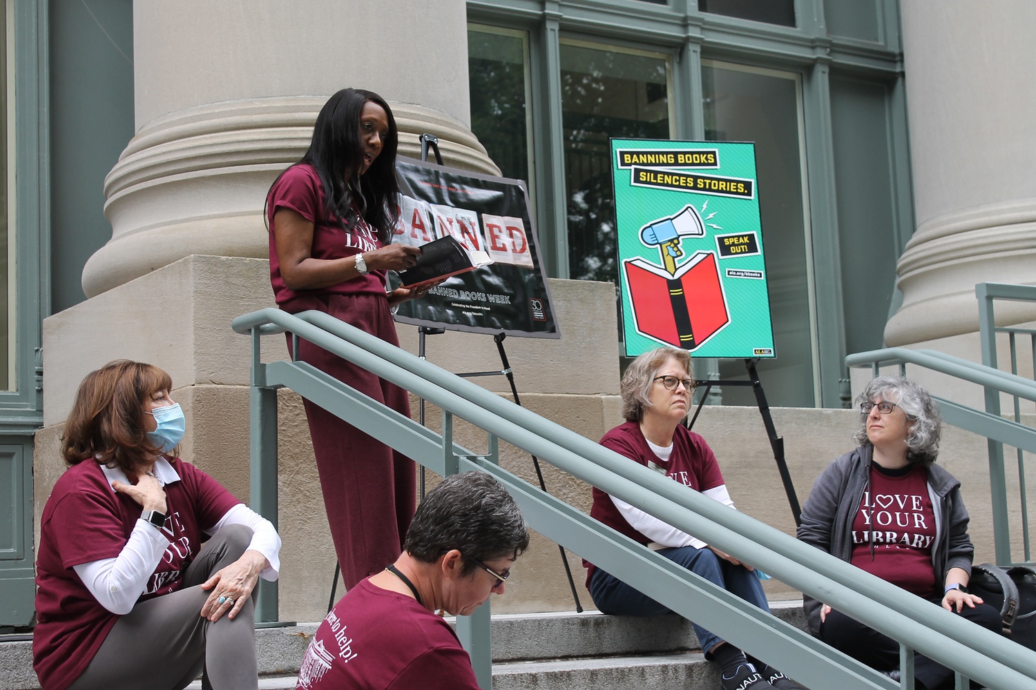 Harvard Law School librarians and staff members read from their favorite banned books on the steps of the Harvard Law School library.