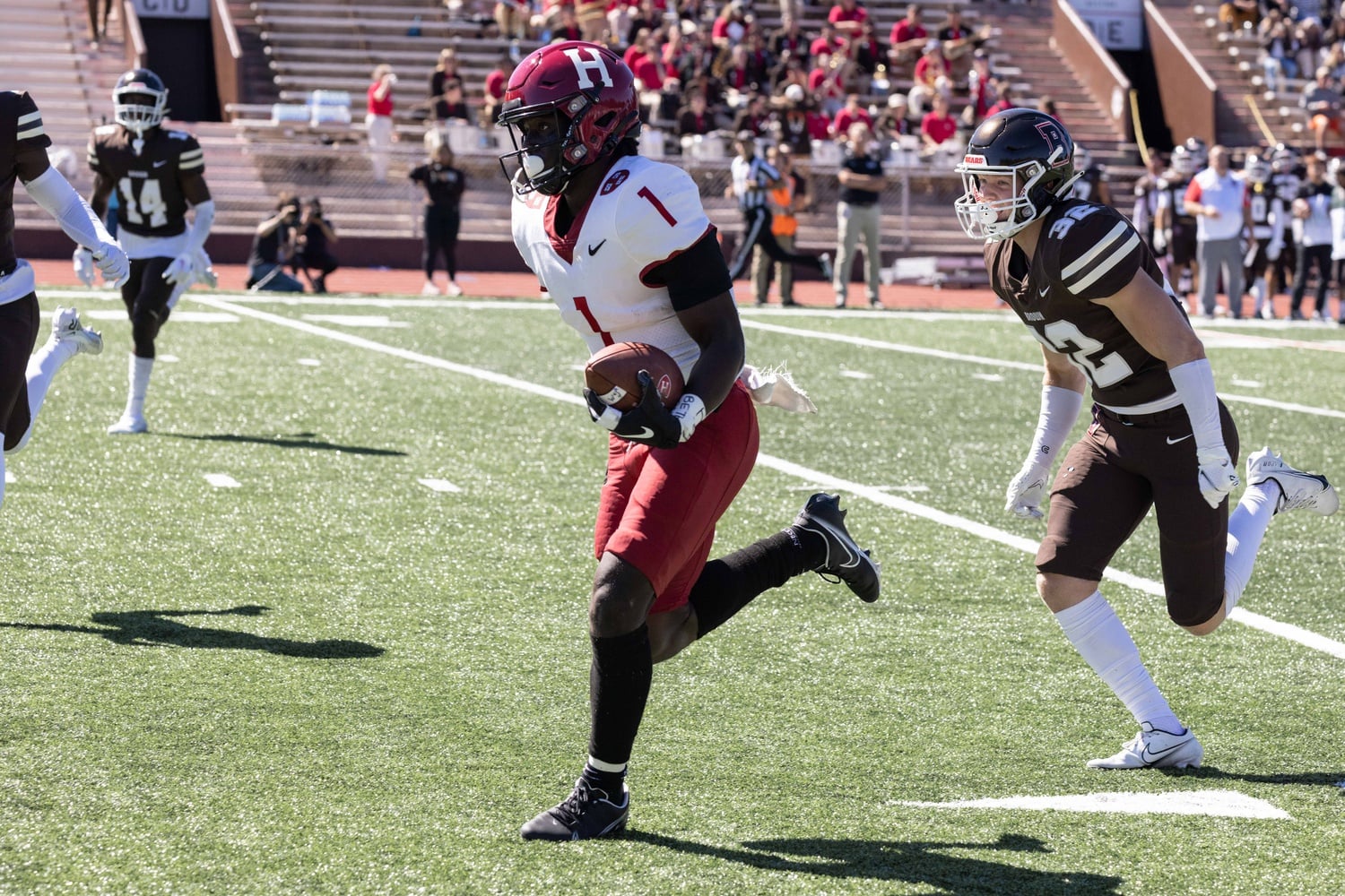 Senior wide receiver Kym Wimberly outraces the Brown defense on Saturday's 35-28 victory. Wimberly scored the team's first two touchdowns of the contest.