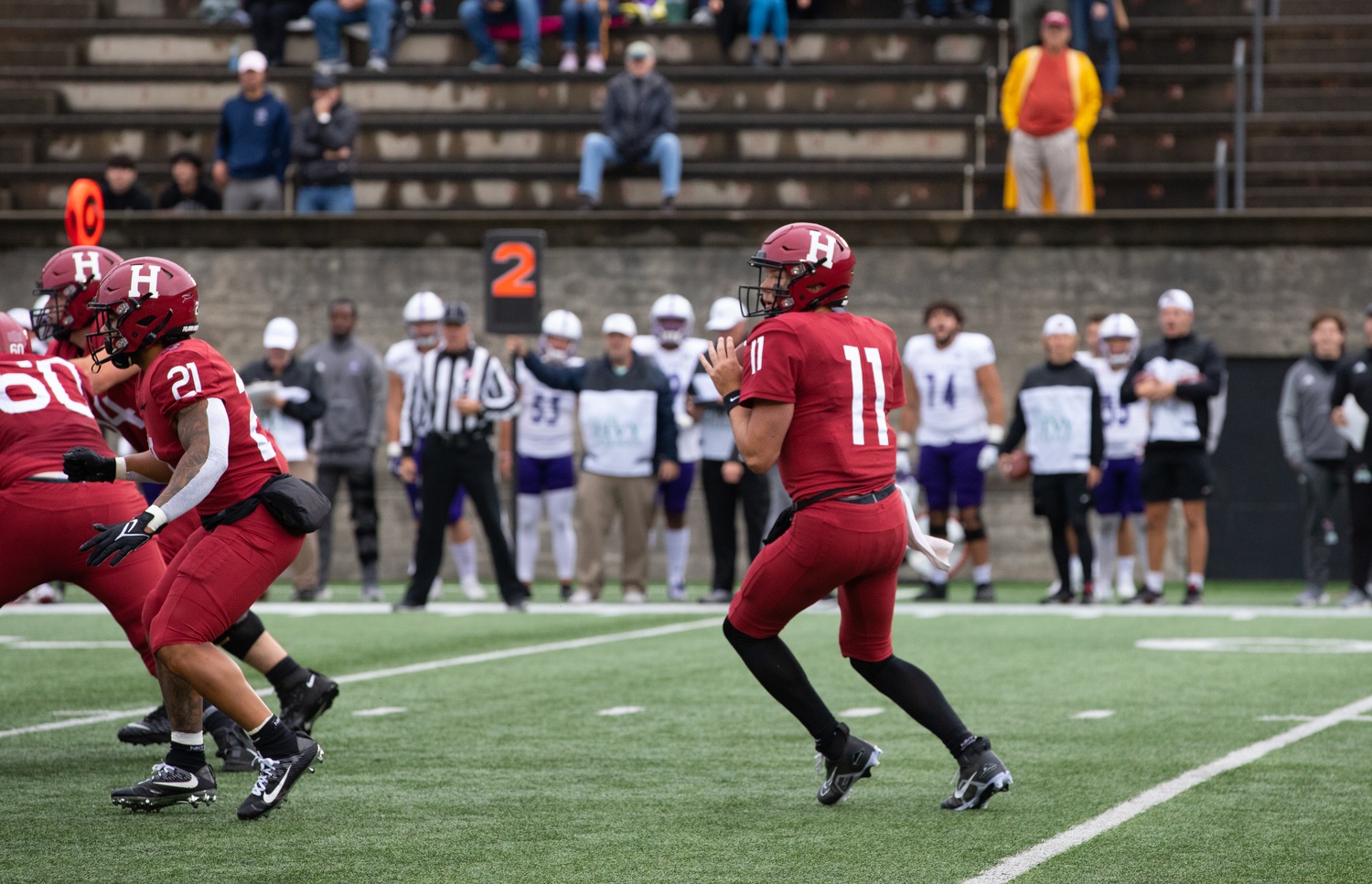 Senior quarterback Charlie Dean drops back to pass in Saturday's 30-21 loss to Holy Cross. Despite the loss, Dean completed multiple deep dimes in the contest, including one to senior wide receiver Kym Wimberly for a touchdown.