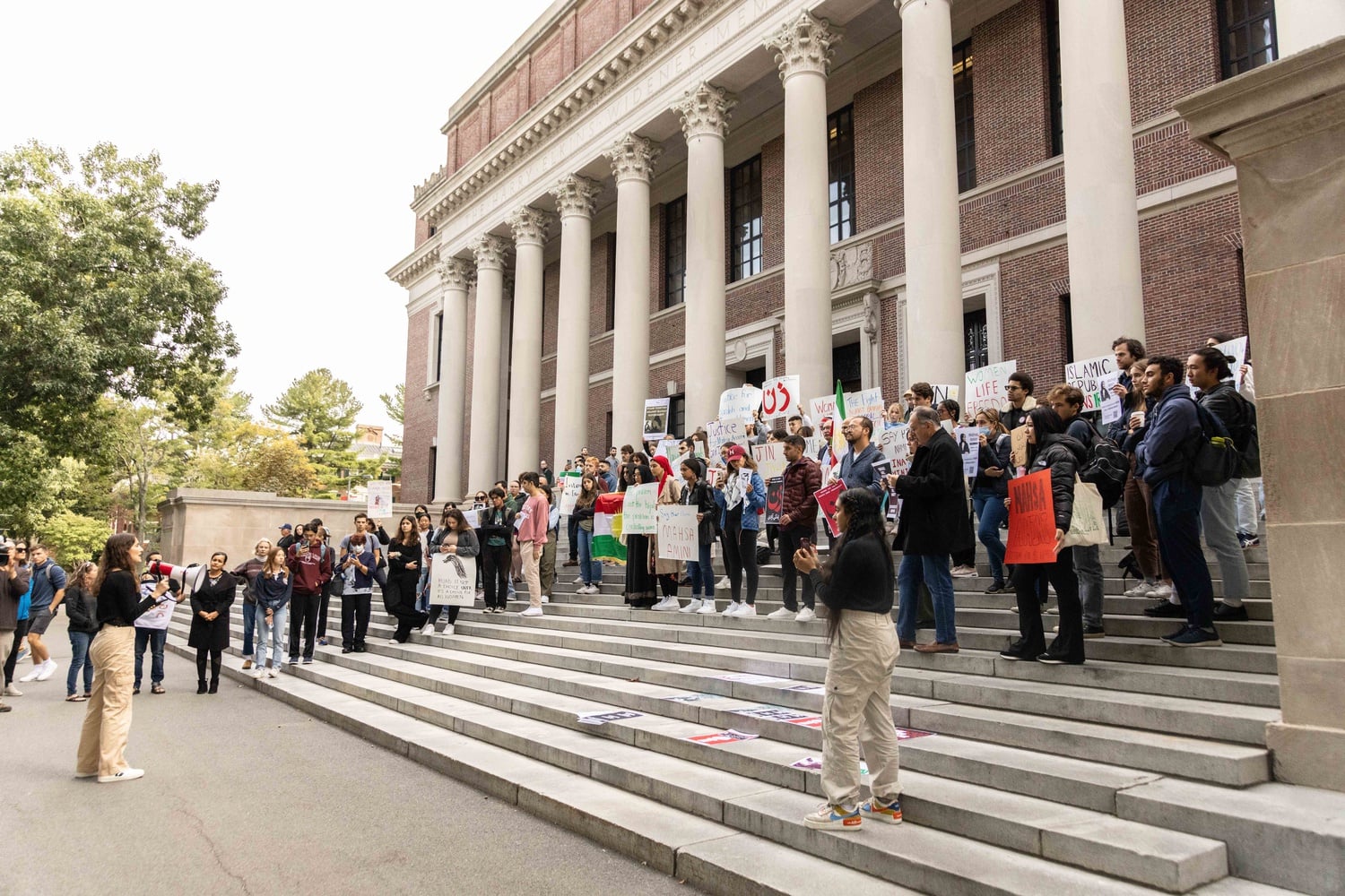 Harvard affiliates gathered in front of Widener Library Friday to protest government restrictions on women in Iran.
