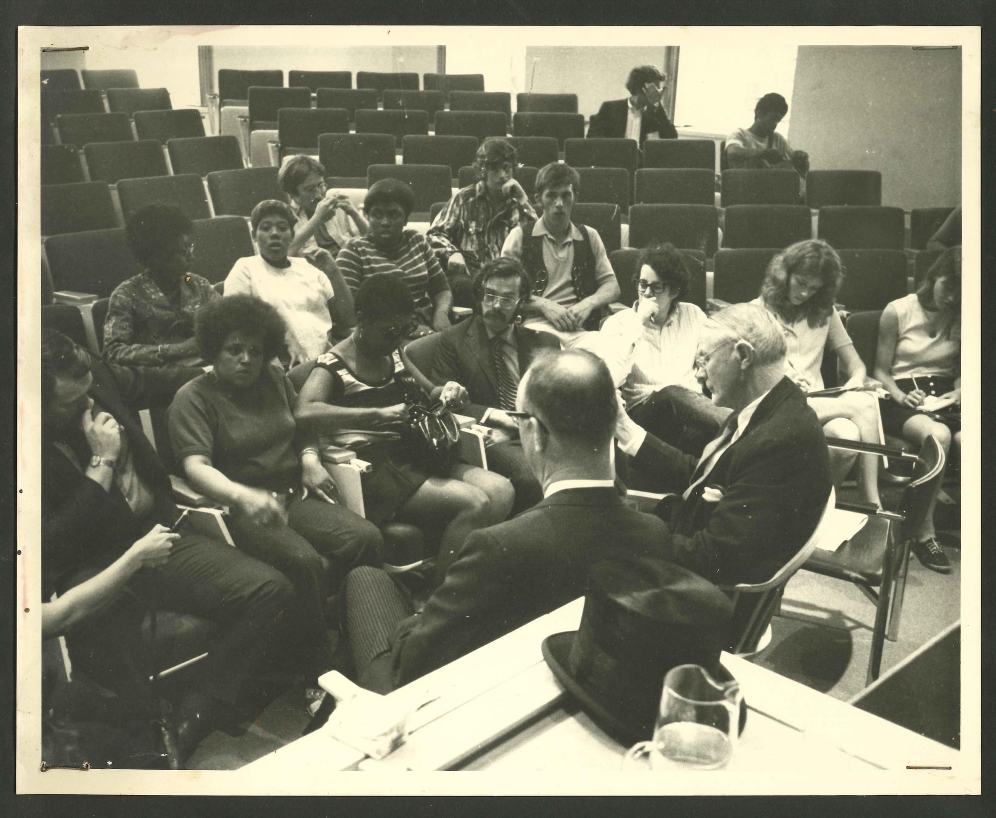 Following the Commencement protest, Graham and a delegation from the Riverside Planning Team meet with members of the Harvard Corporation in a lecture hall on June 11, 1970.