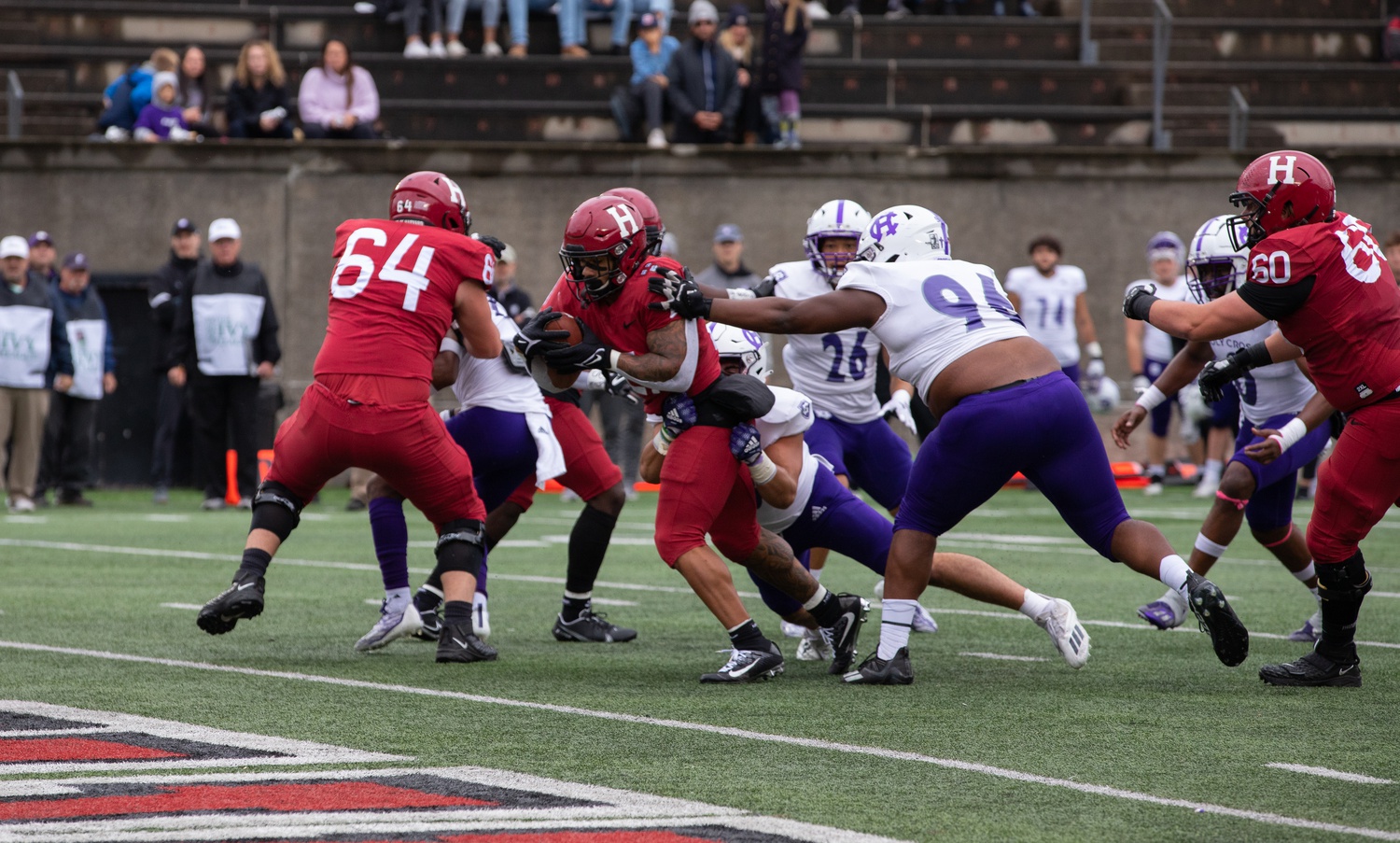 Senior running back Aidan Borguet breaks through a tackle for a seven-yard score in a 30-21 loss to Holy Cross on Oct. 1. Borguet took a career-high 28 carries for 163 yards and a score on Friday.