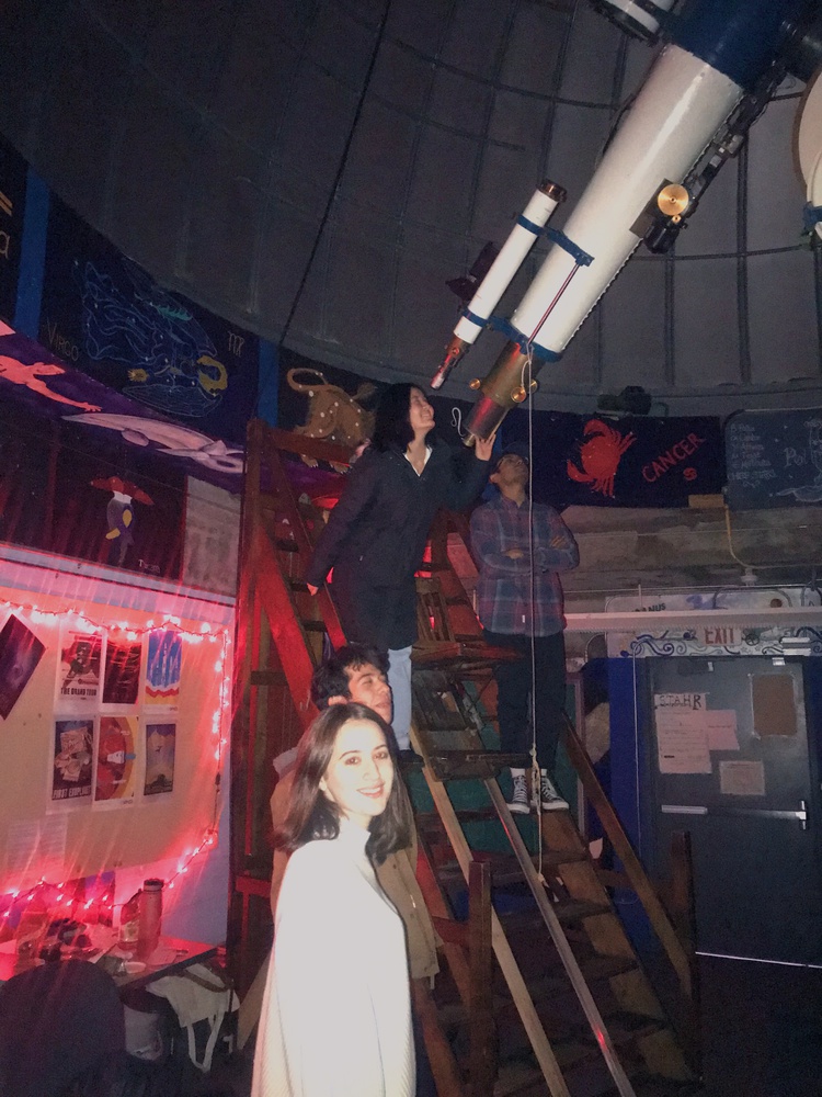 Students line up to peer through the telescope at the Loomis-Michael Observatory atop the Science Center.