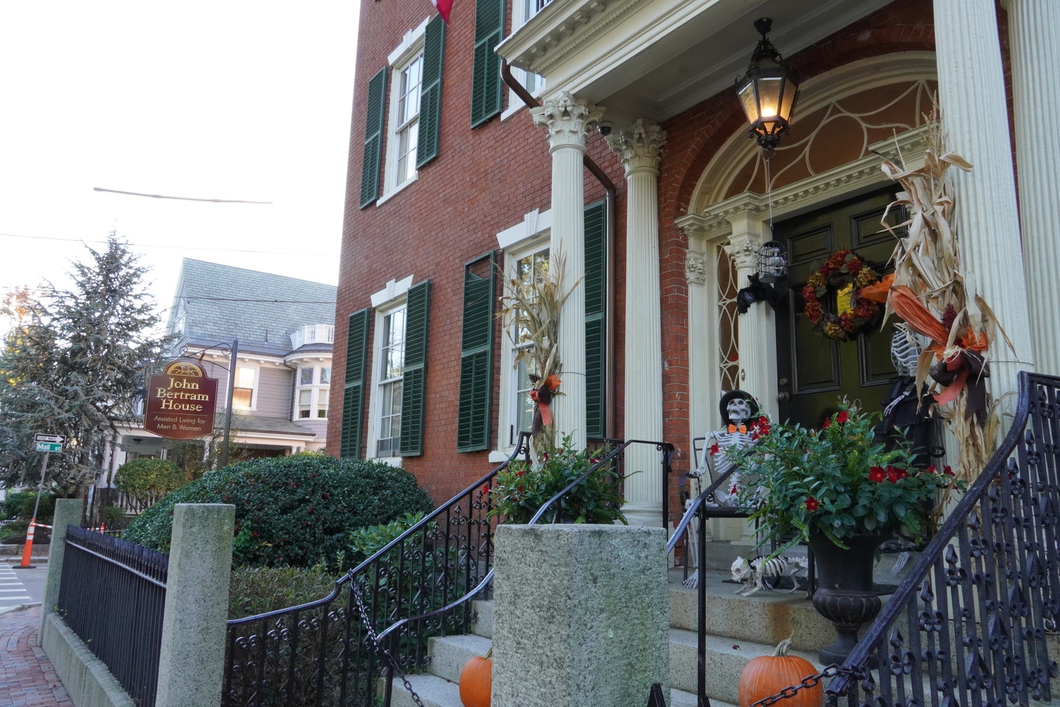 Skeletons and autumnal accoutrements decorate the front step of a house in Salem.