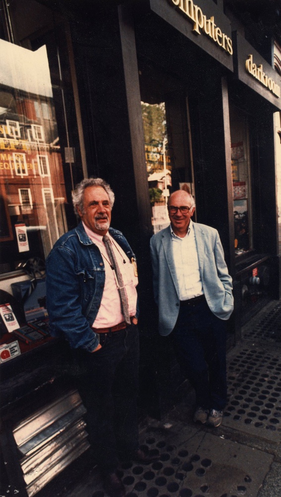 Ferranti stands outside of his camera shop, Ferranti-Dege.