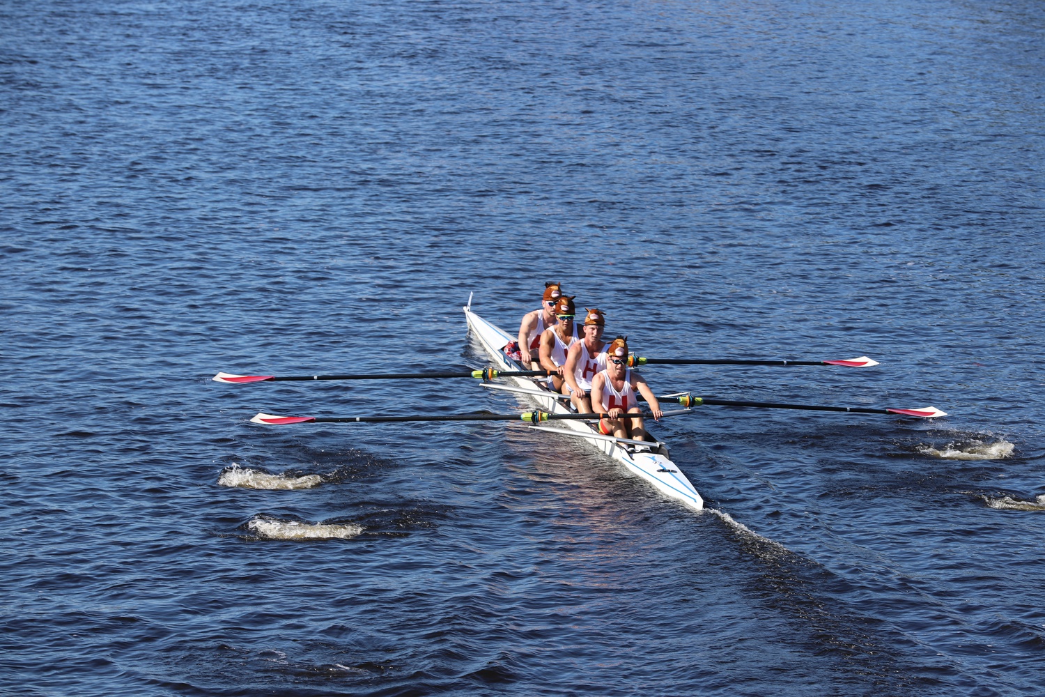 A four-man crew of Harvard racers strokes down the Charles River during the 2021 Head of the Charles Regatta, on Oct. 23, 2021.