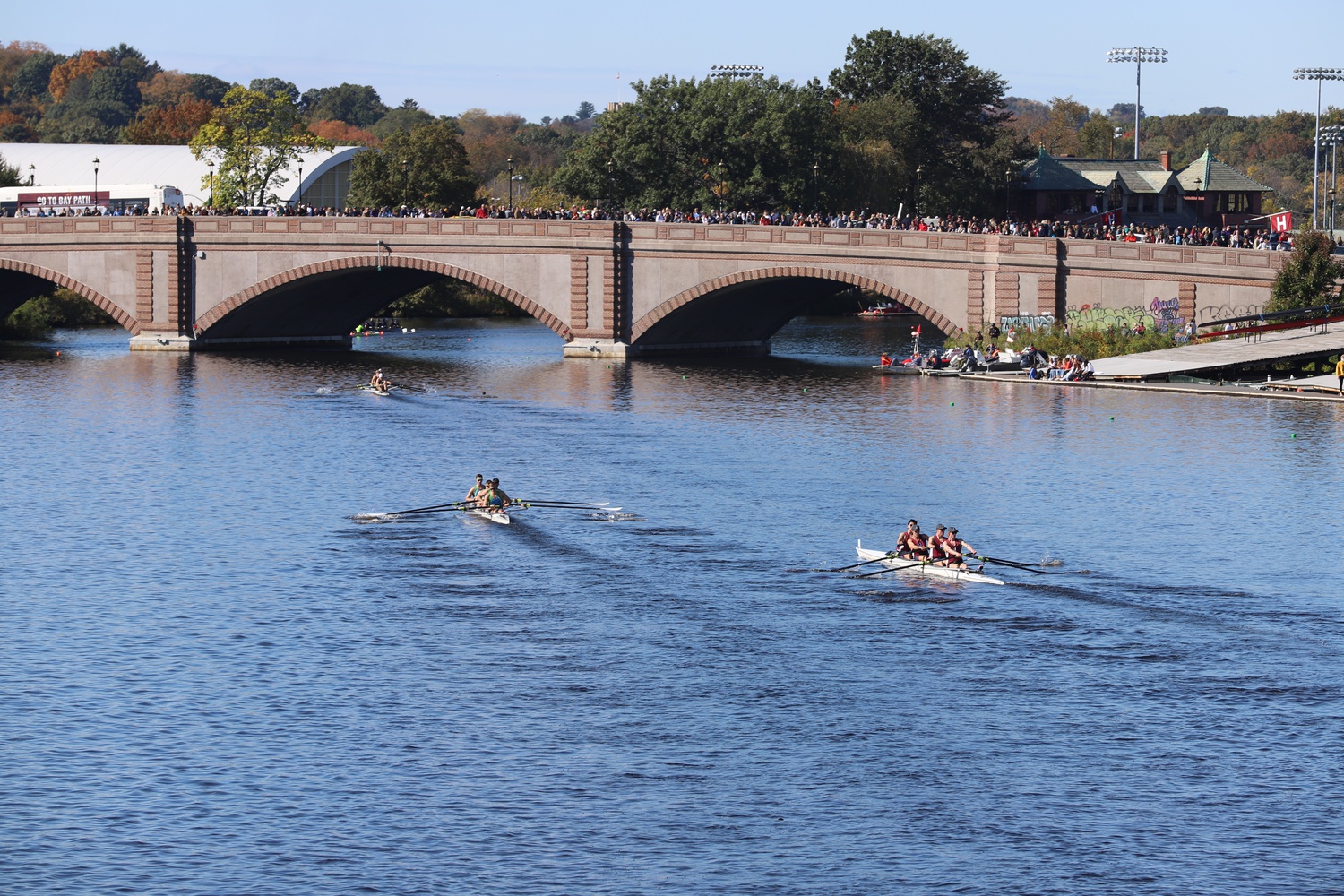 A Harvard crew rows past the Anderson Memorial Bridge as part of the 2021 Head of the Charles Regatta, on Oct. 23, 2021.
